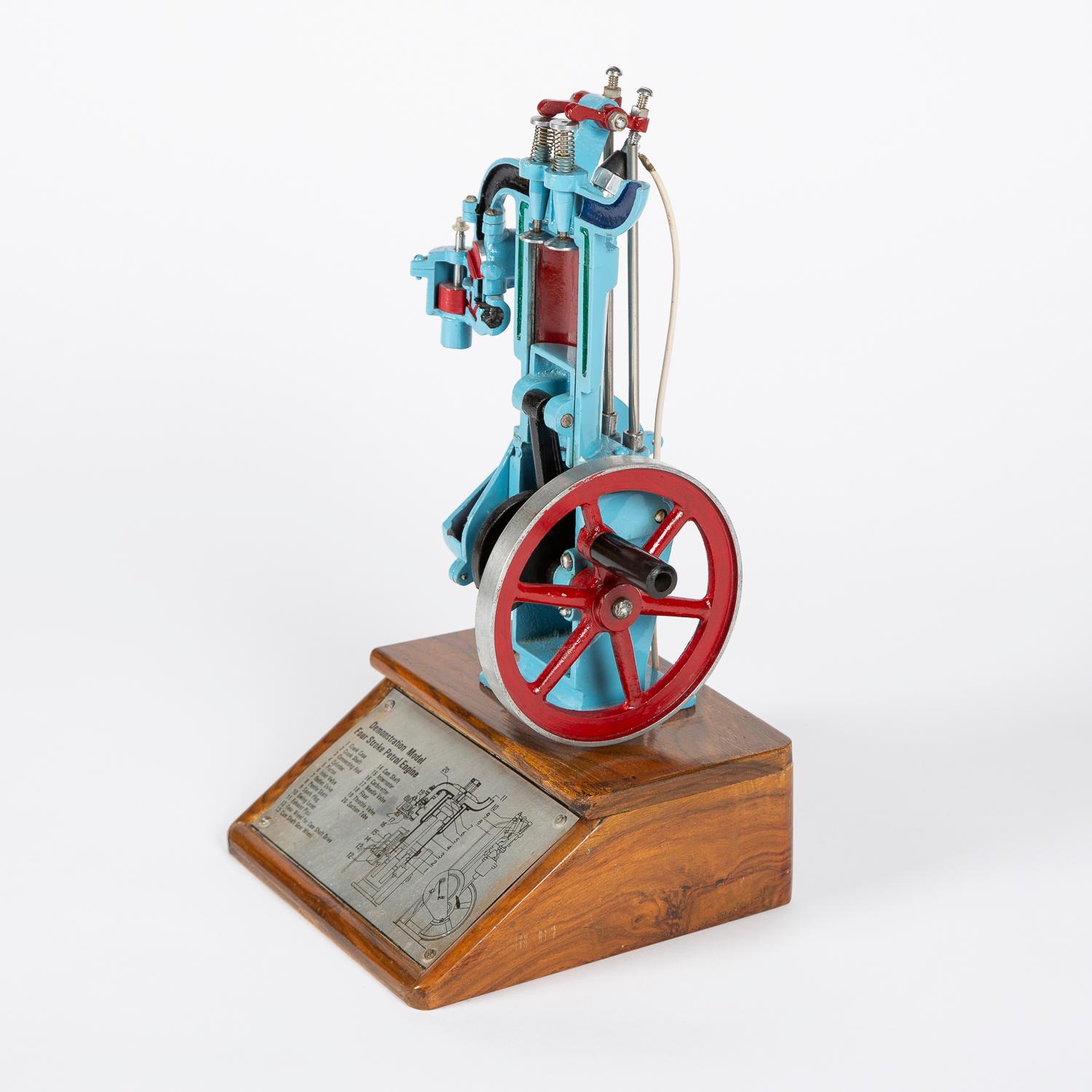 A cutaway demonstration model of a four stroke petrol engine, circa 1960.

This model of an internal combustion engine is hand cranked, the main parts of the engine move through the stages of the 4 strokes, ignition is shown when the bulb at the
