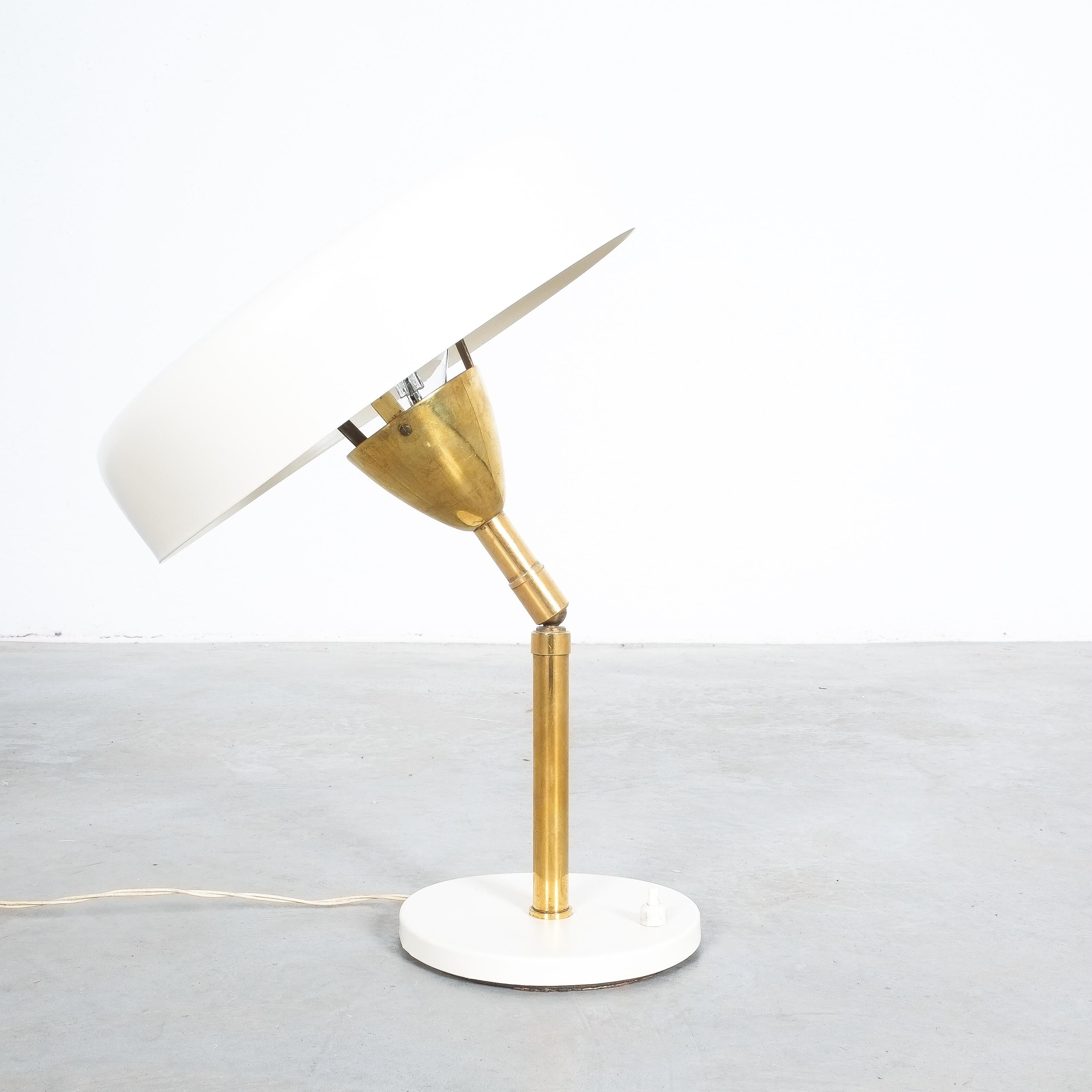 Cute fully 360 degree adjustable pivoting table light, Italy, circa 1955

Very beautiful and fully functional small Italian table light from eggshell colored lacquered sheet metal and brass. It is in very good vintage condition, showing minor