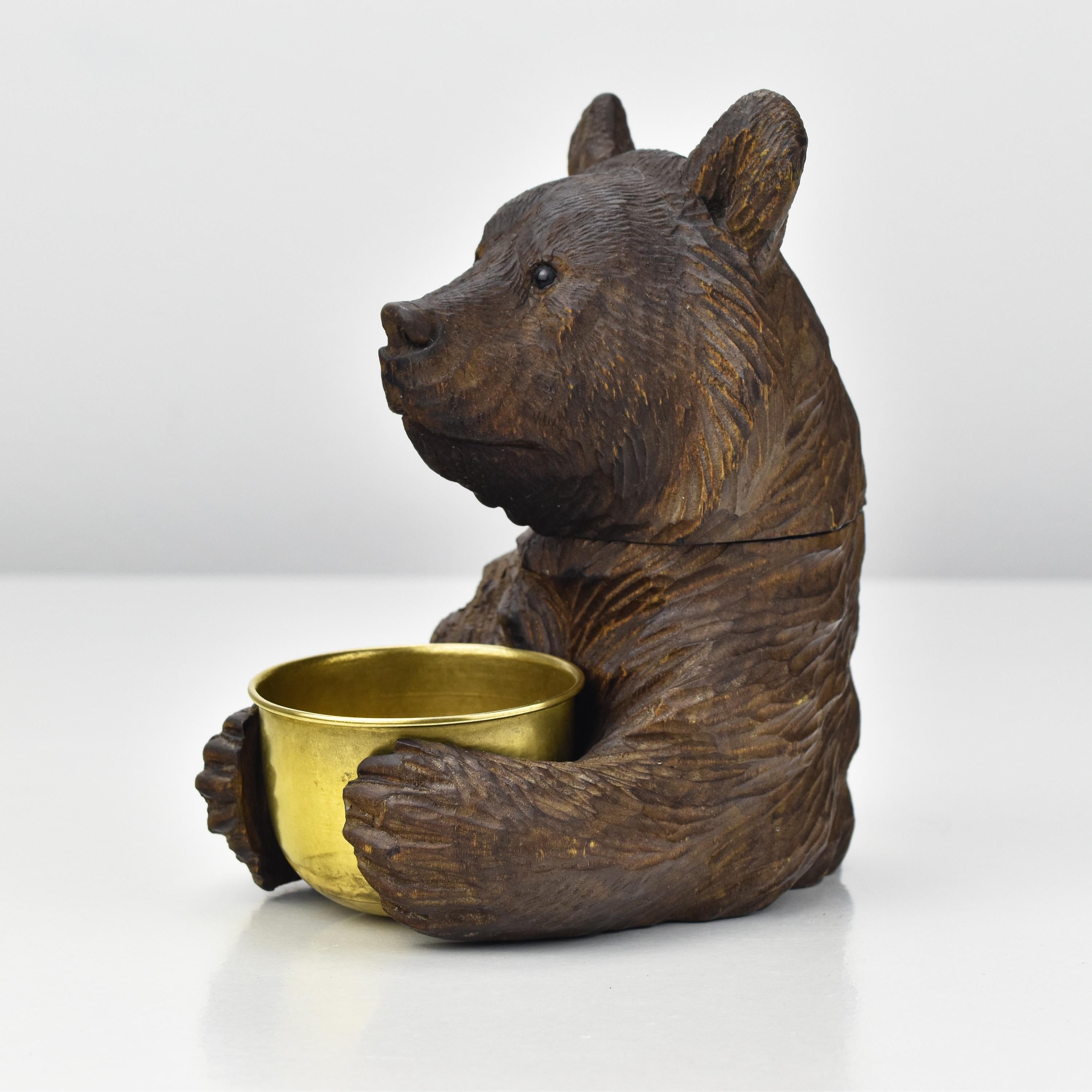 Ths antique German or Swiss bear figurine is a really lovely item and a remarkable piece of craftsmanship regarding its fine carving, dating back to approximately 1880. 

Carved from linden wood with a dark patina, it exudes a sense of old-world