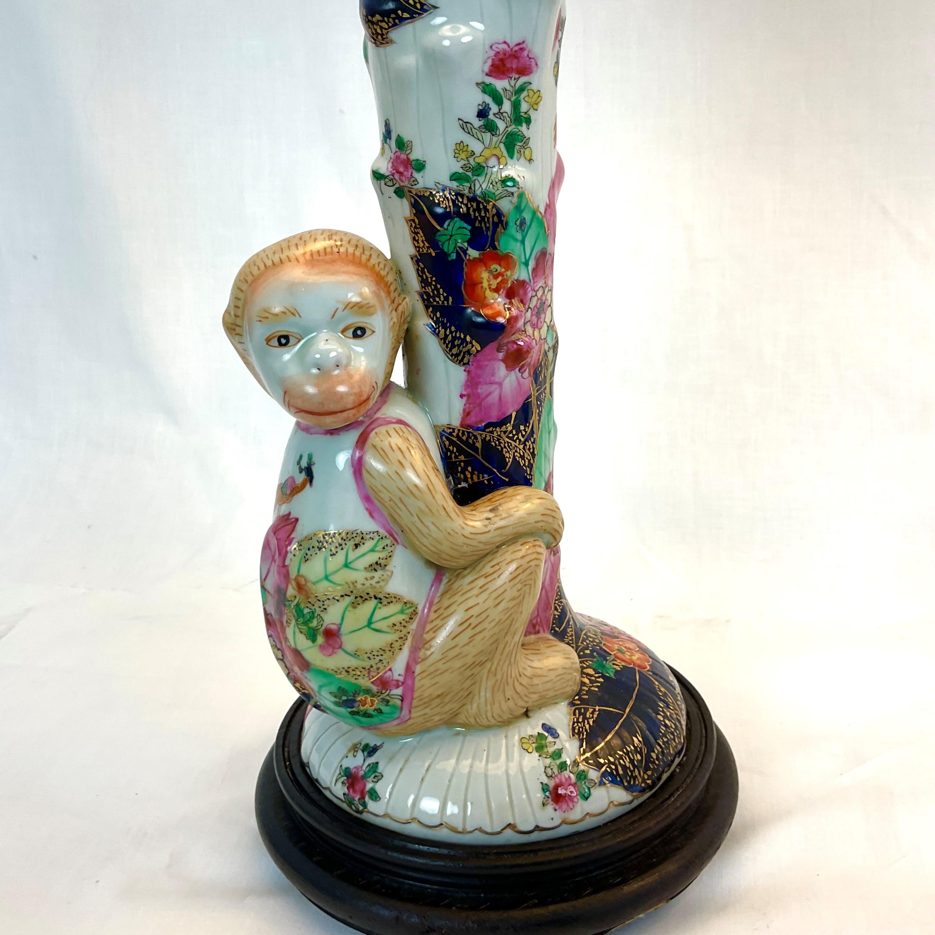 Very charming Japanese porcelain hand-painted monkey lamp pair on wood-footed bases with white linen shades and amethyst finials. Ready to place on a lovely entry hall table or buffet. Perfect condition with new shades.