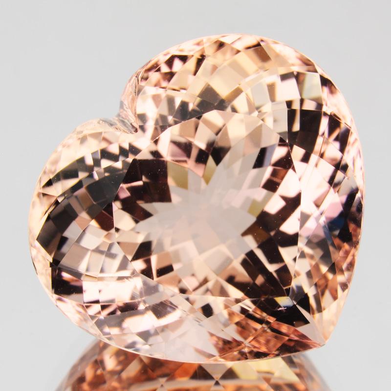 Morganite is the pink to orange-pink variety of beryl, a mineral that includes emerald and aquamarine. Blends of pink and orange are typical natural morganite colors. 

This stone is relatively free of inclusions, giving it a desirable clear