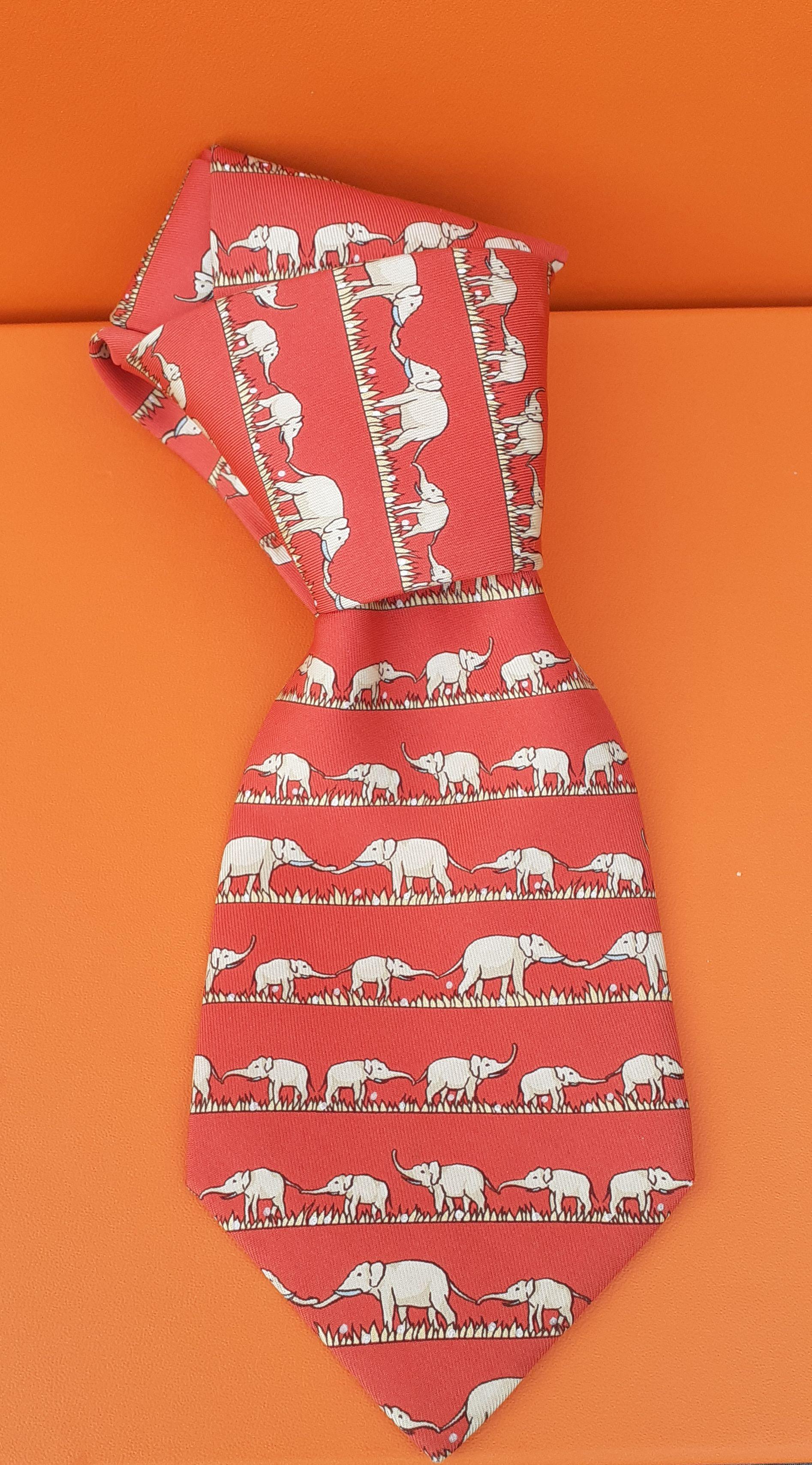 Beautiful Authentic Hermès Tie

Pattern: Elephants

Probably from 2005

Made in France

100% Silk

Colorways: Red background, Beige Elephants and polka dots, Pale Yellow Grass 

Lined with plain red silk

