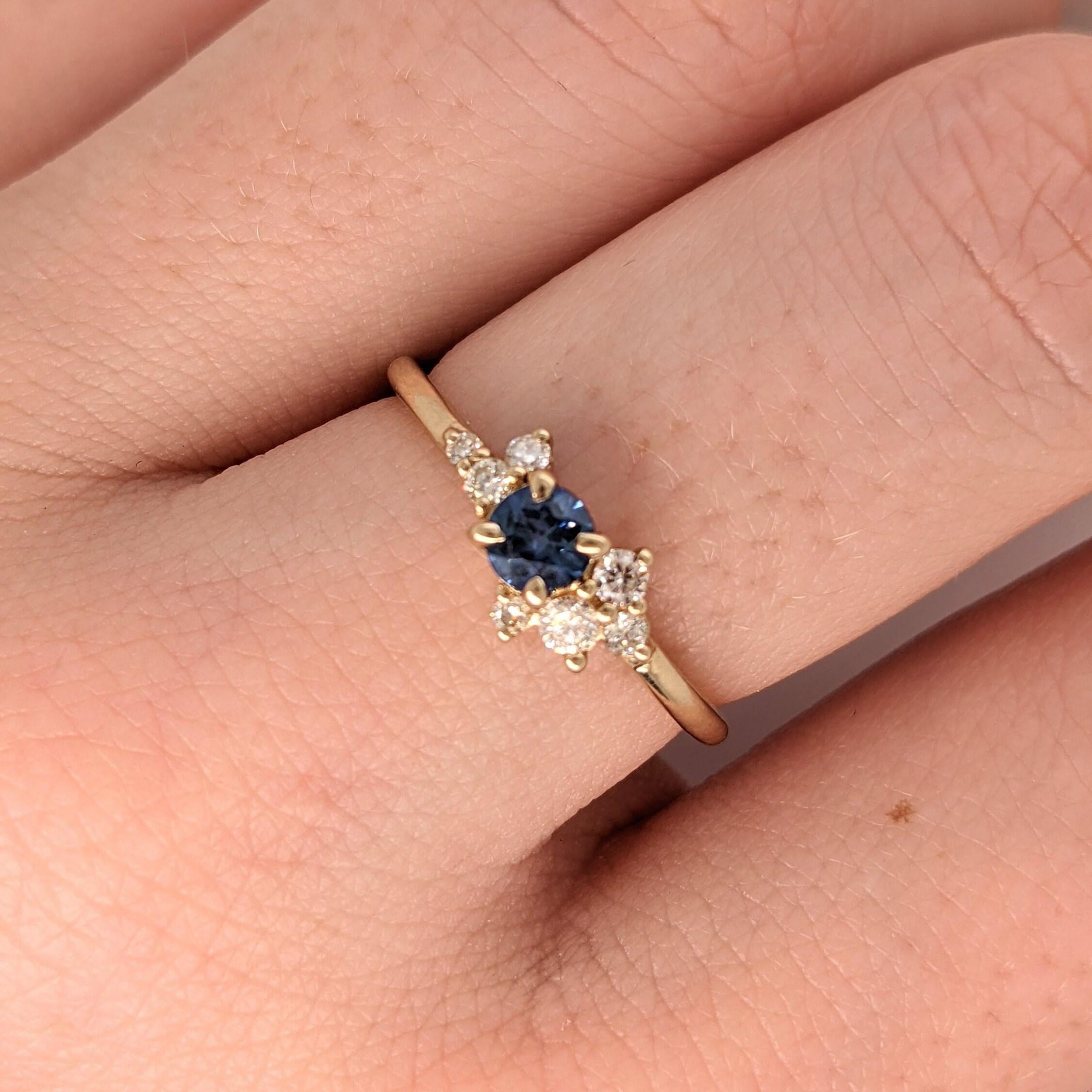 This simple and sleek blue sapphire ring is made for the minimalist in your life! With asymmetrical diamond accents around a blue sapphire, this piece is subtle and classy. Its sturdy band allows for every day, worry-free wear. This ring can be a
