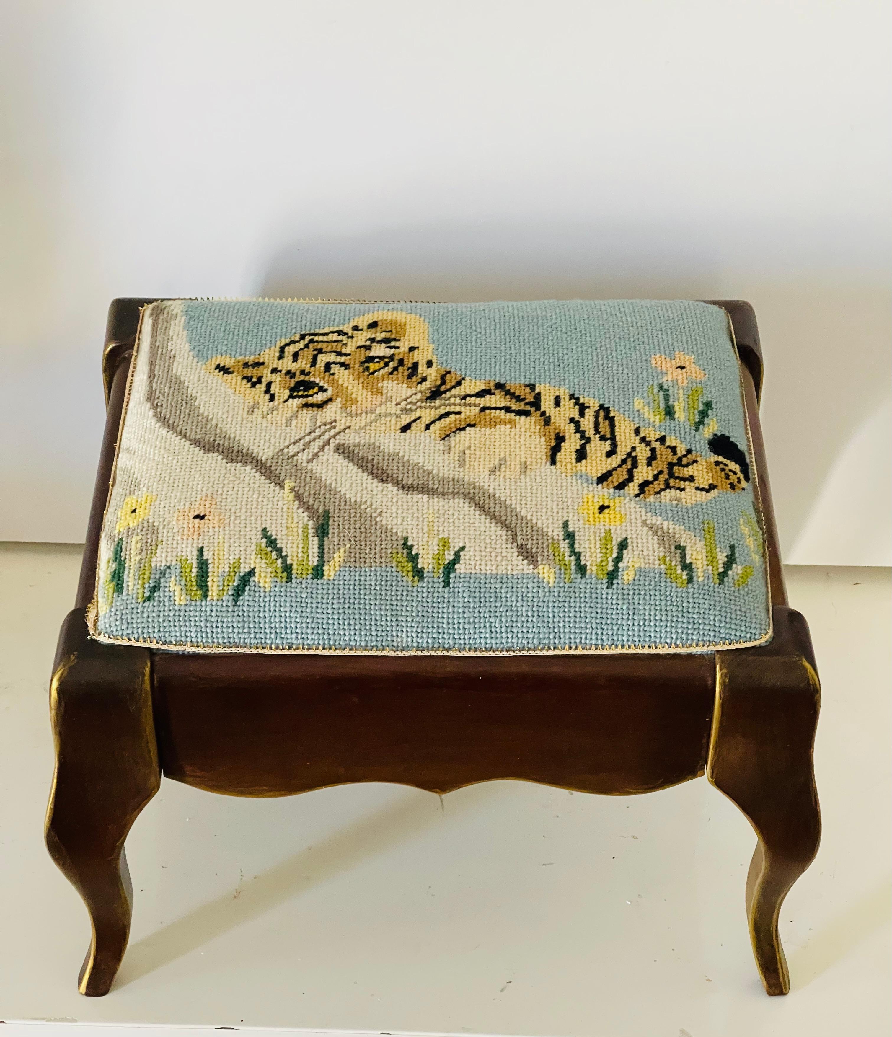 Cute small American needlepoint footstool. Cabriole legs, baby tiger needlepoint. Gold trim accents on wood and on top around the needlepoint.