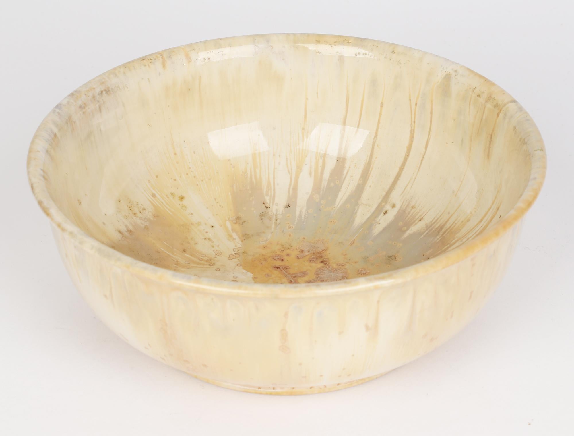 A rare and stunning Art Deco Doulton Lambeth ceramic bowl decorated in cream, brown and grey crystalline glazes by Cuthbert Bailey and dating from around 1925. The wide rounded bowl stands on a narrow foot rim with a raised edge and folded back rim.