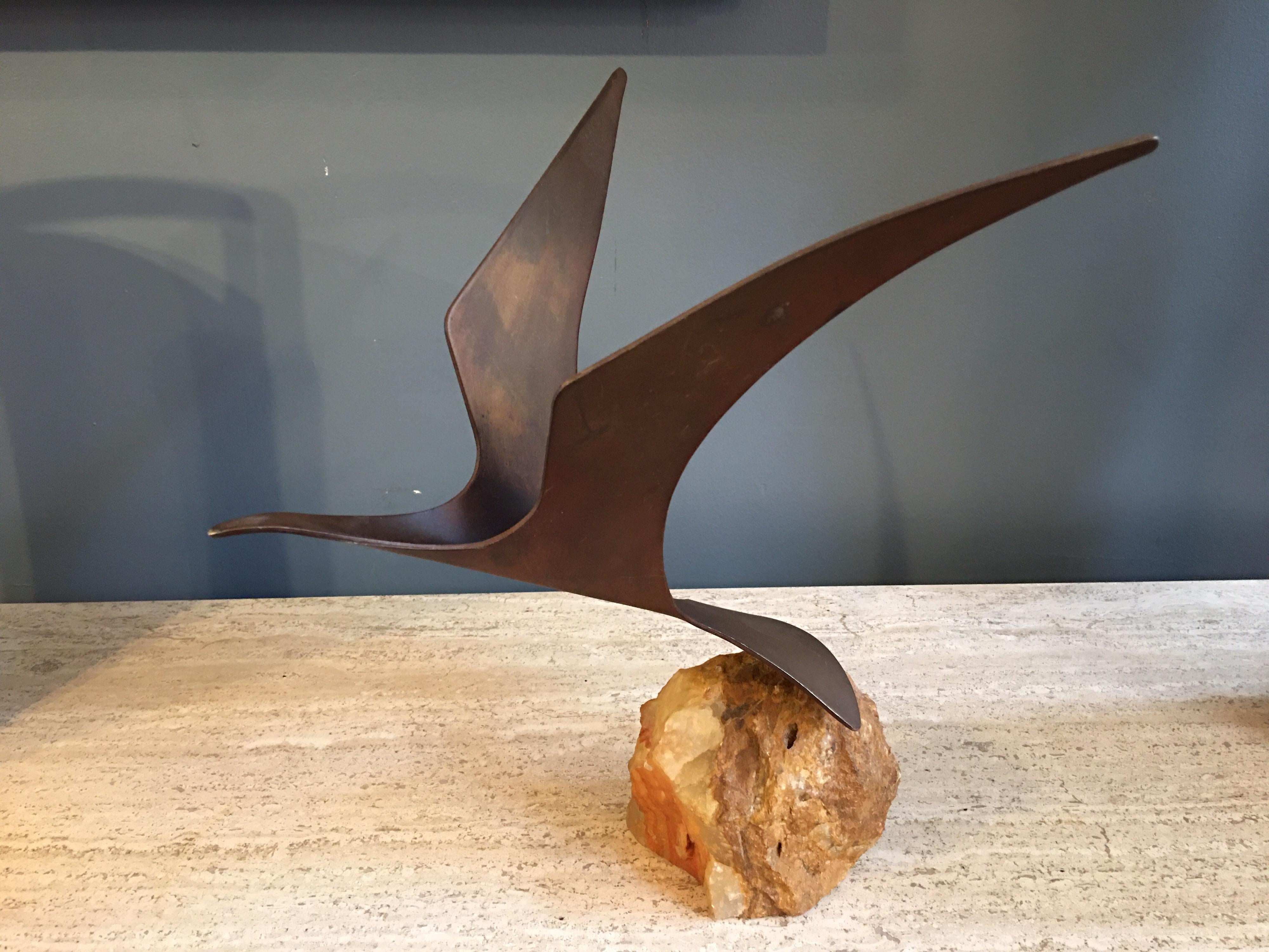 Curtis Jere signed metal seagull on a rough cut stone vase. Can be turned on rock in many positions.
