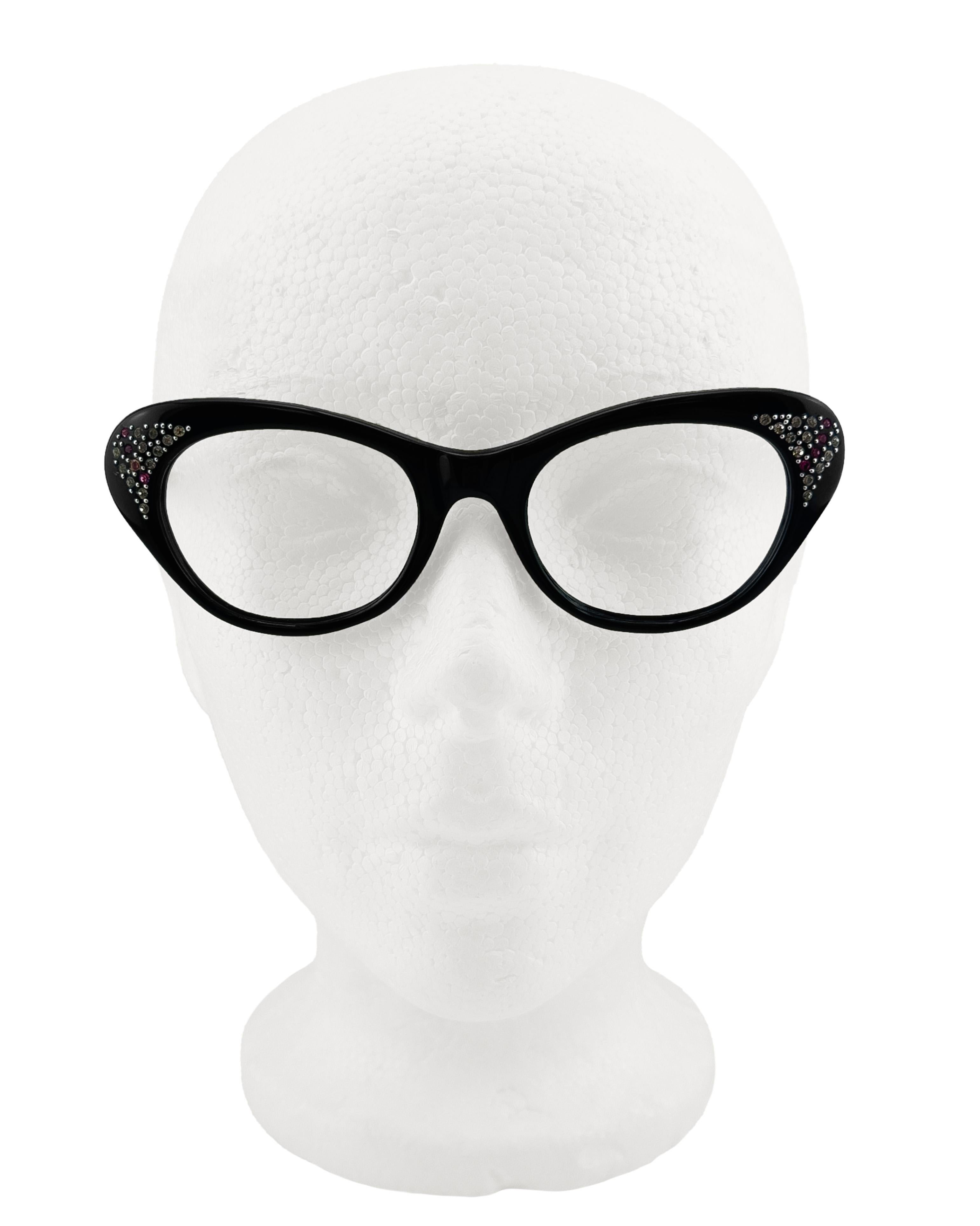 Cutler and gross cat eye black Italian acetate frames with red and clear crystal accents on the tips. Famous for their iconic designs and favoured by celebrities like Elton John, these cats-eye frames are for the bold at heart. The resurgence of