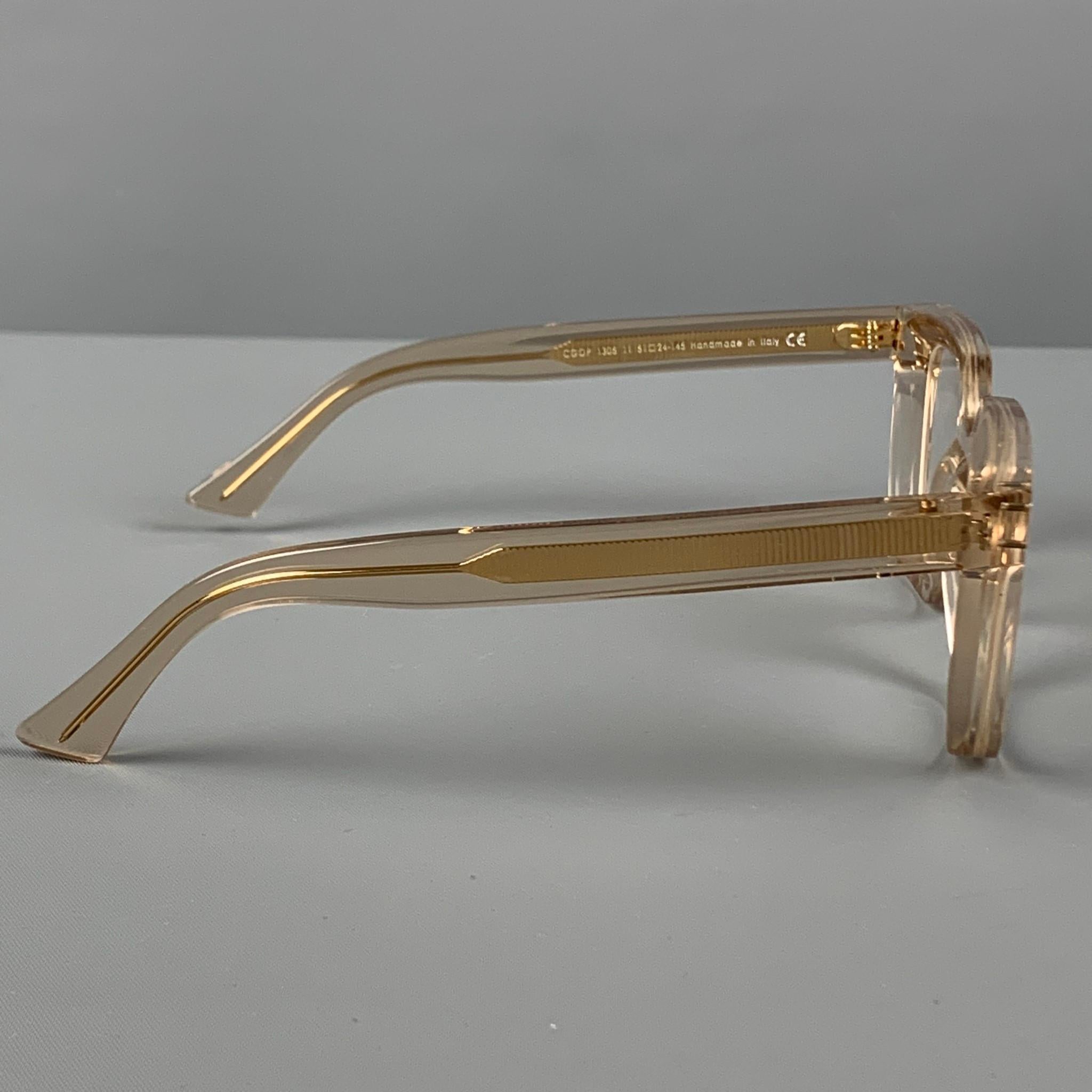 CUTLER AND GROSS sunglasses comes in a clear & gold tone acetate featuring clear lenses. Includes box. Handmade in Italy. 

Excellent Pre-Owned Condition.
Marked: CG0P 1305 11 51-25-145
Original Retail Price: $495.00

Measurements:

Length: 15