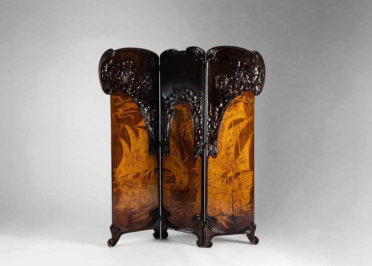 An Italian folding screen in the Liberty Style (the Italian equivalent of Art Nouveau) by the Florentine furniture makers Girard & Cutler who earned the Gold Medal during the Turin Exposition of 1902. The piece is in carved maple, walnut, mahogany,