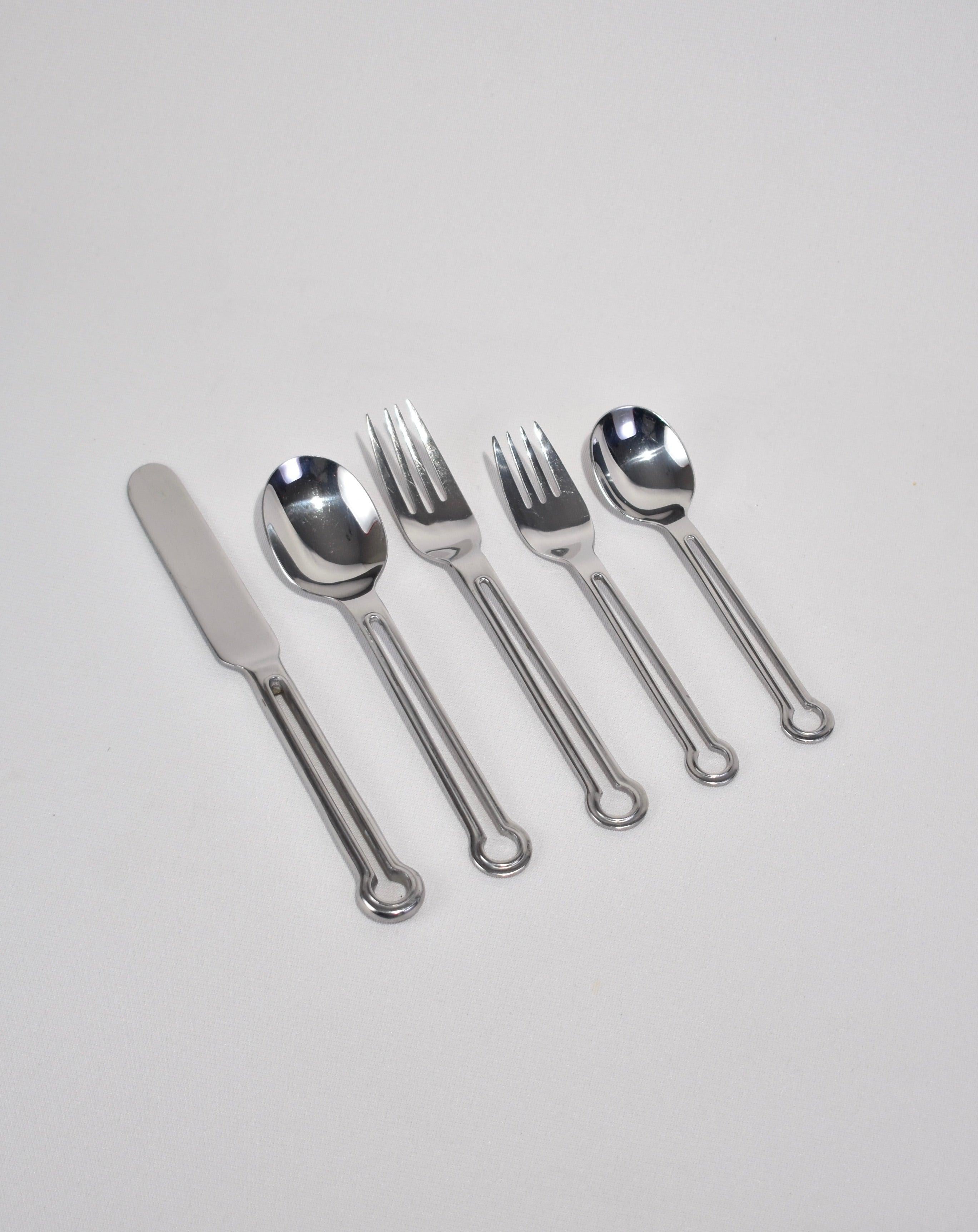 Rare, stainless steel five-piece flatware set with cutout handle. Stamped Oxford Hall, Stainless Korea.

Purchase includes one set of five pieces, two sets available.
