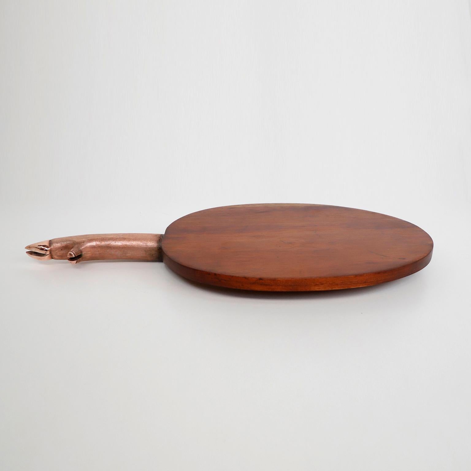 circa 1970. We offer this Cutting and Presenting Board Made of Wood and Copper handle in pig's foot form.