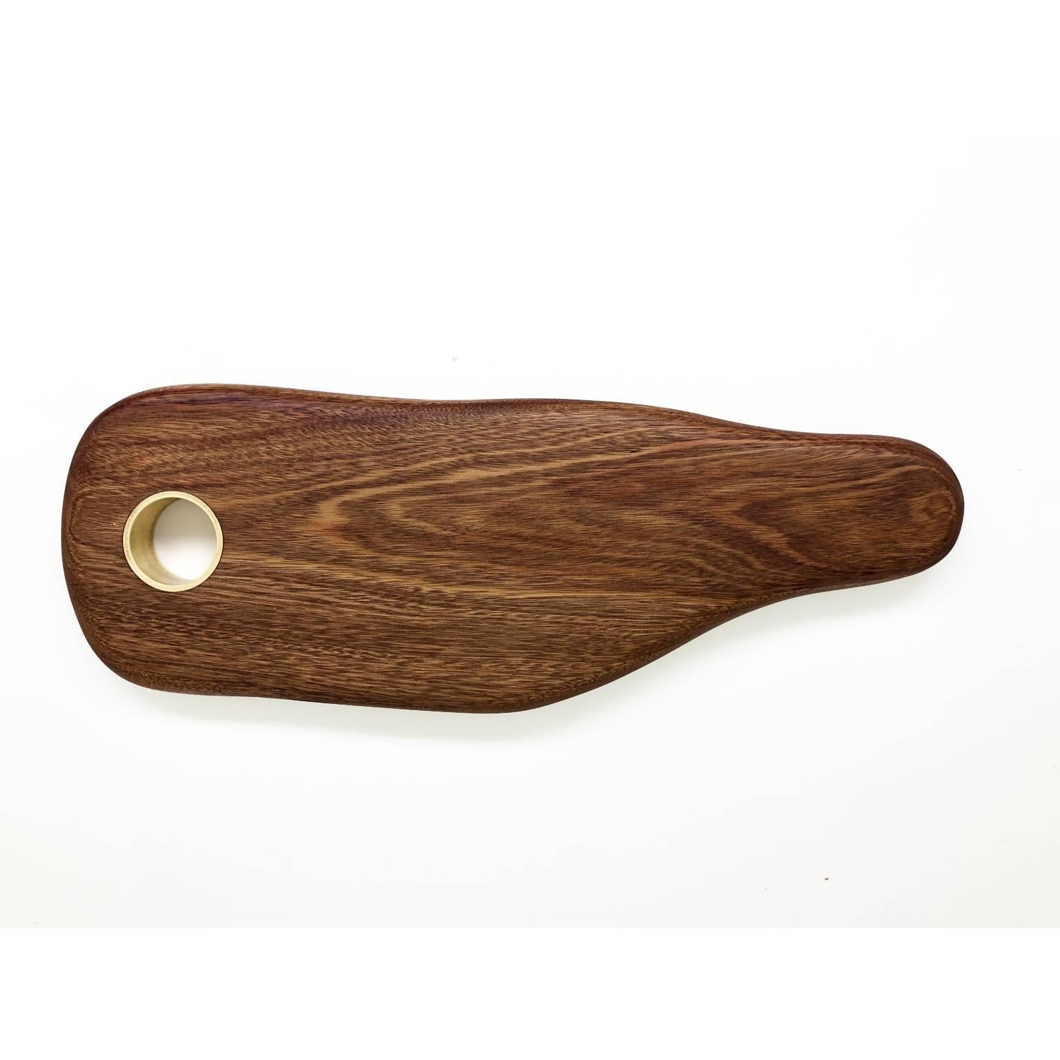 The cutting gourmet board is made in Brazilian solid wood tanibuca with brass insert. Finishing in Italian acrylic matte varnish that shows the beauty of wood.