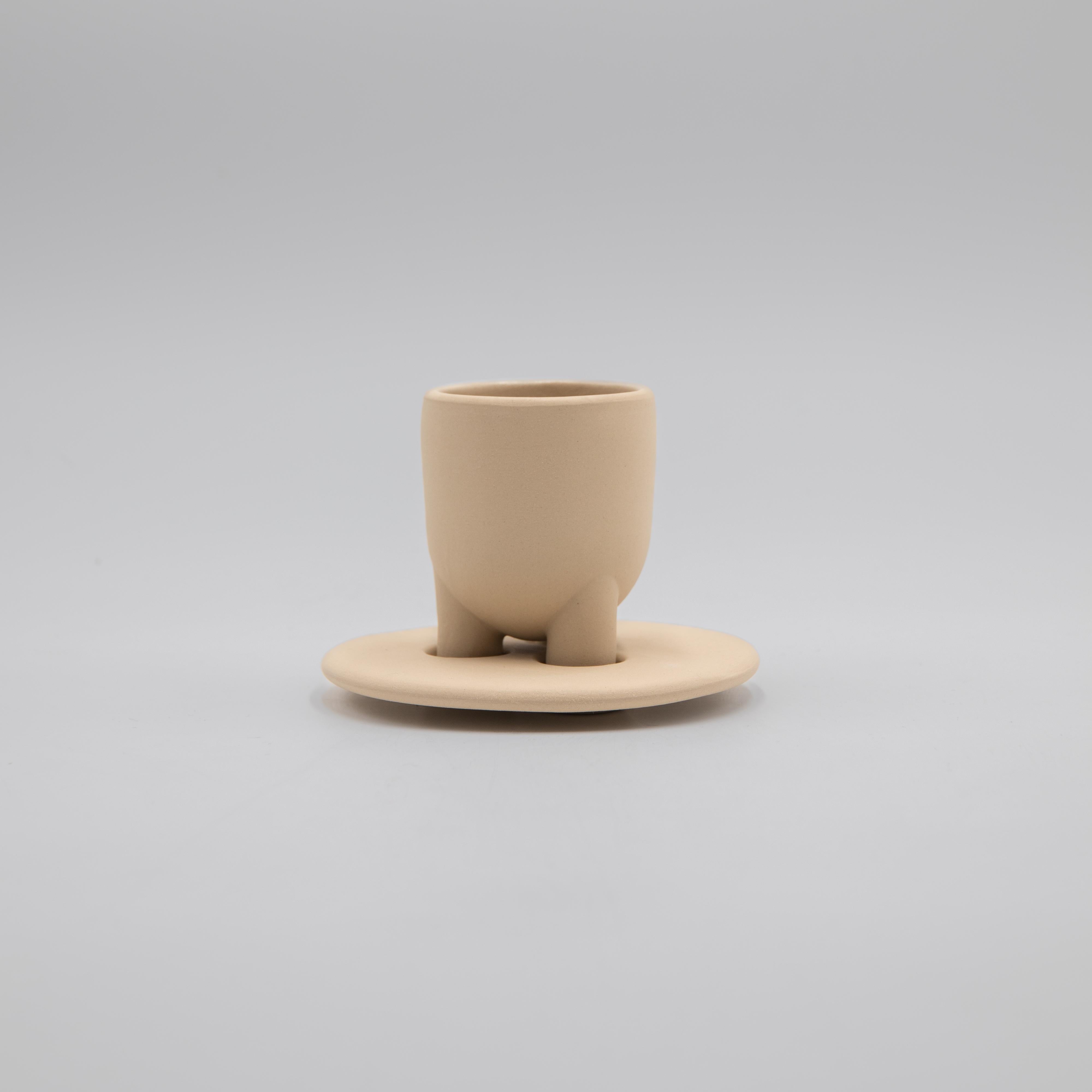 Drawing inspiration from the coffee traditions of Italy and Iran, this stoneware espresso cup and saucer seem both modern and ancient. Simple geometric shapes and clean lines create the unique design with legs that correspond to the saucer.

Made in
