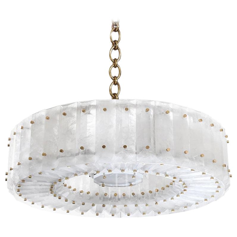 Group of two round rock crystal chandeliers with center section and nickel plating decoration. Finely carved, multi-faceted rock crystal panels installed around the circumference of the circle. Hung from a finely cast polished nickel chain. 
Lead