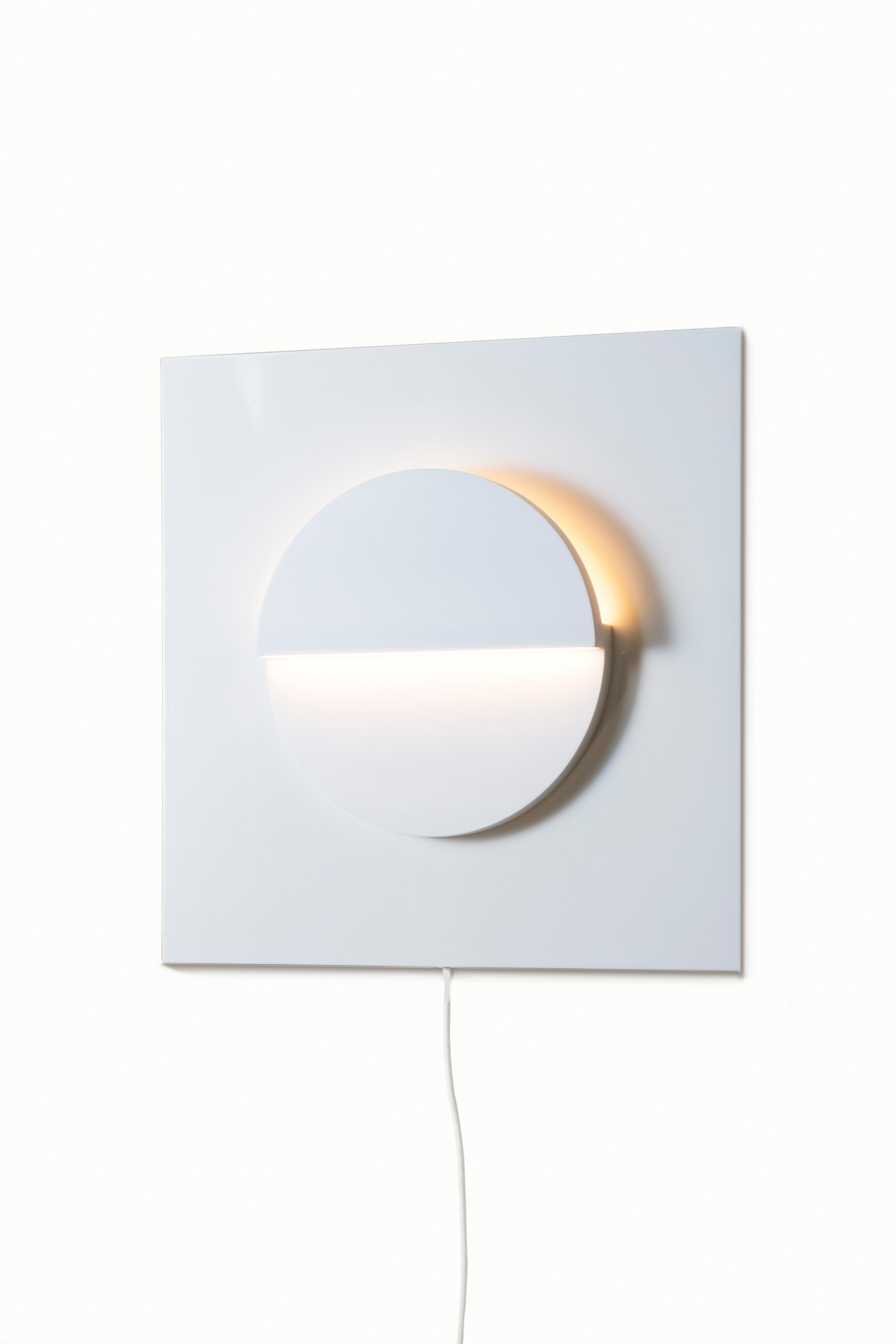 Part of the Cycladic Series, exploring the power of architecture brought to small scale. The framed circle sconce illuminates the purity, symbolism and intimate power of elemental geometric forms expressed in both nature and our manmade world. A