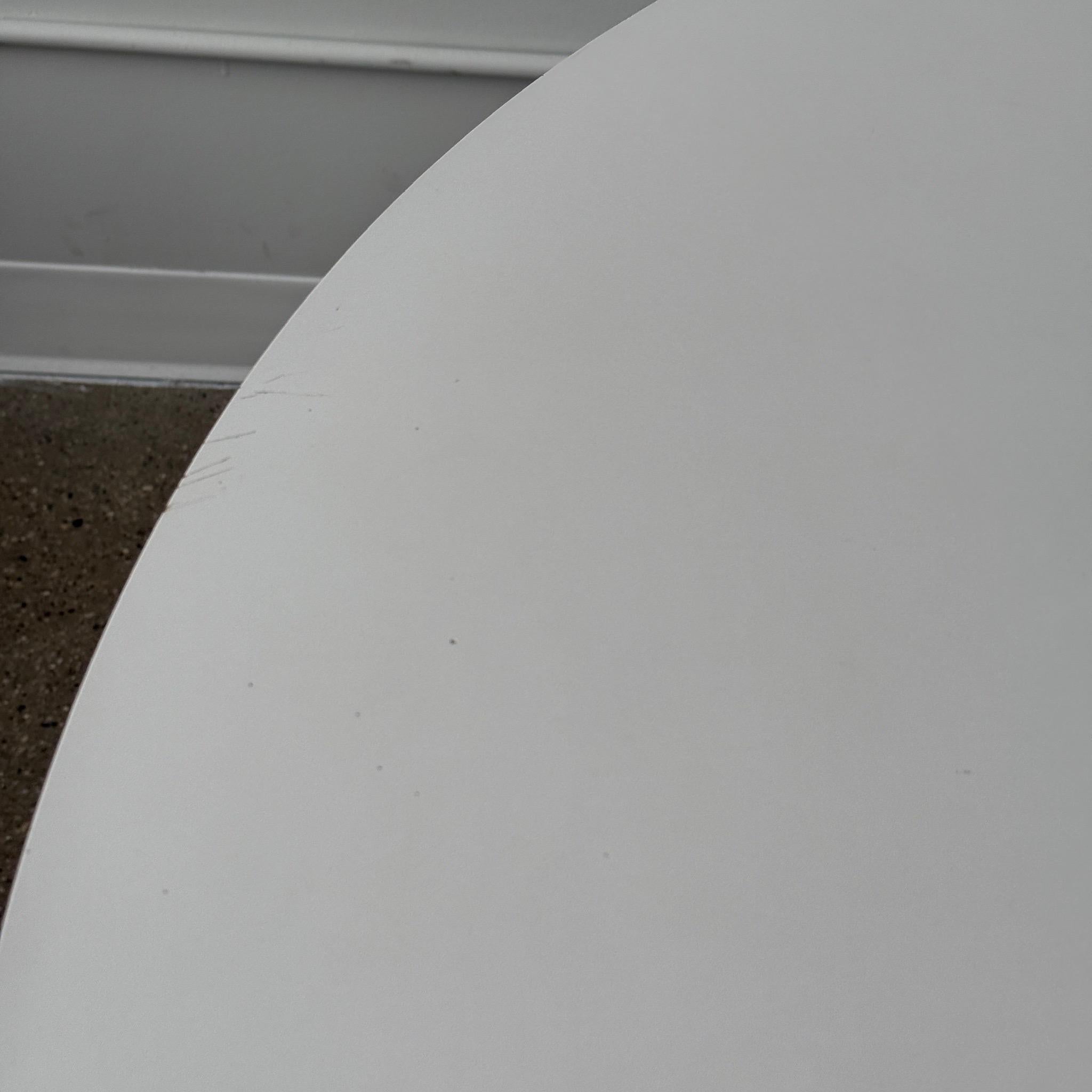c. 1960s. Original cyclone table with metal base and white laminate top. Tagged with 1960s Knoll label. 

