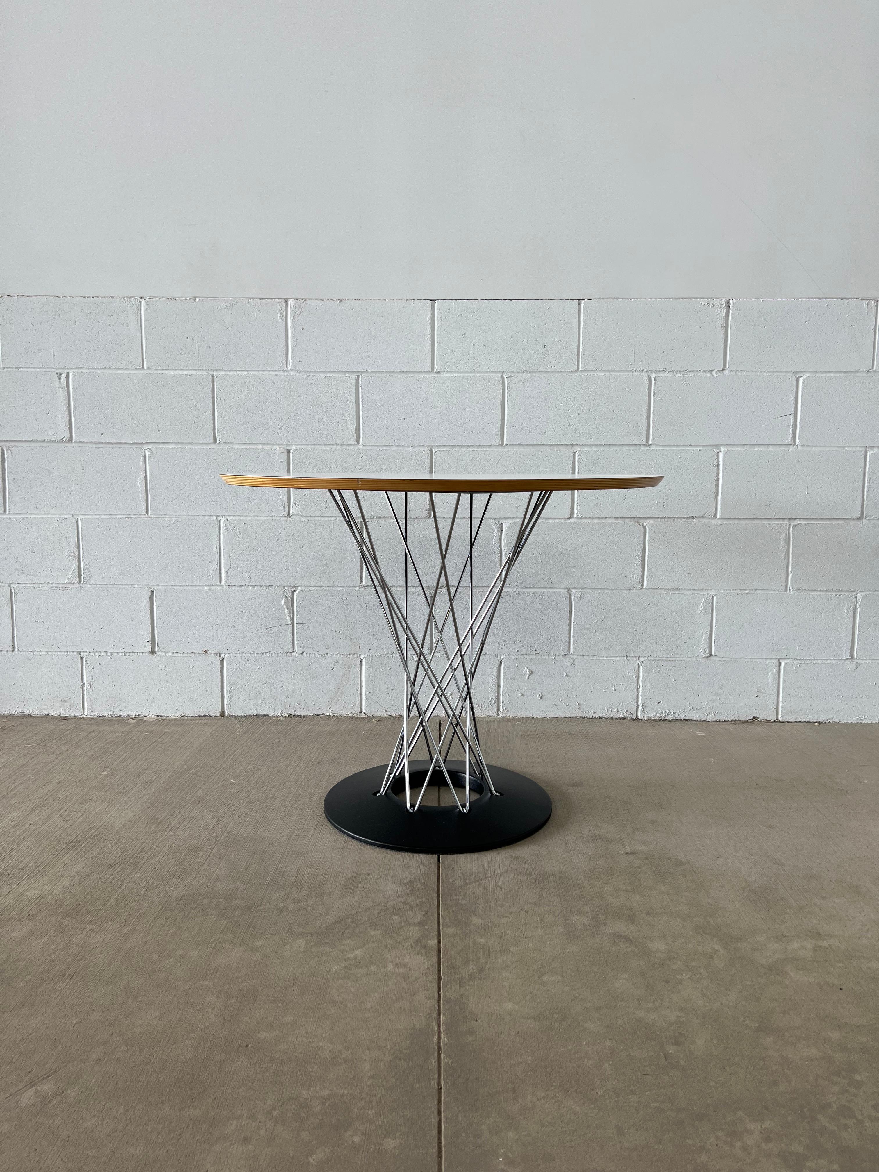 Based on the rocking stool (two available in our inventory), the Cyclone table is a scaled-up adaptation. The table borrows the same interwoven design from the stool but the base features a hollowed center that enhances the 