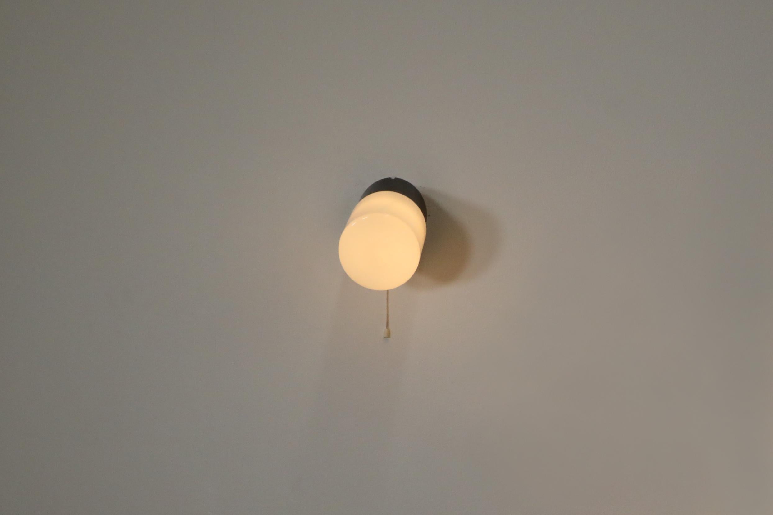Cylinder Milk Glass Sconce with Black Bakelite Base and Pull String Switch In Good Condition For Sale In Los Angeles, CA