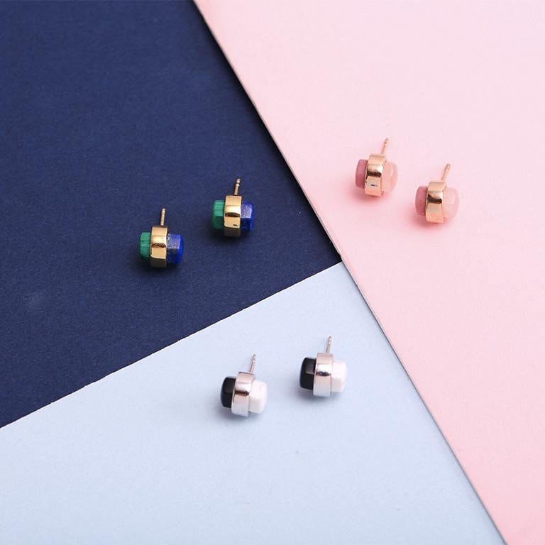 The statement stud. Bringing new life to an otherwise industrial shape, this pair of earrings features pink silver with two precious stones: rose quartz and rhodonite.