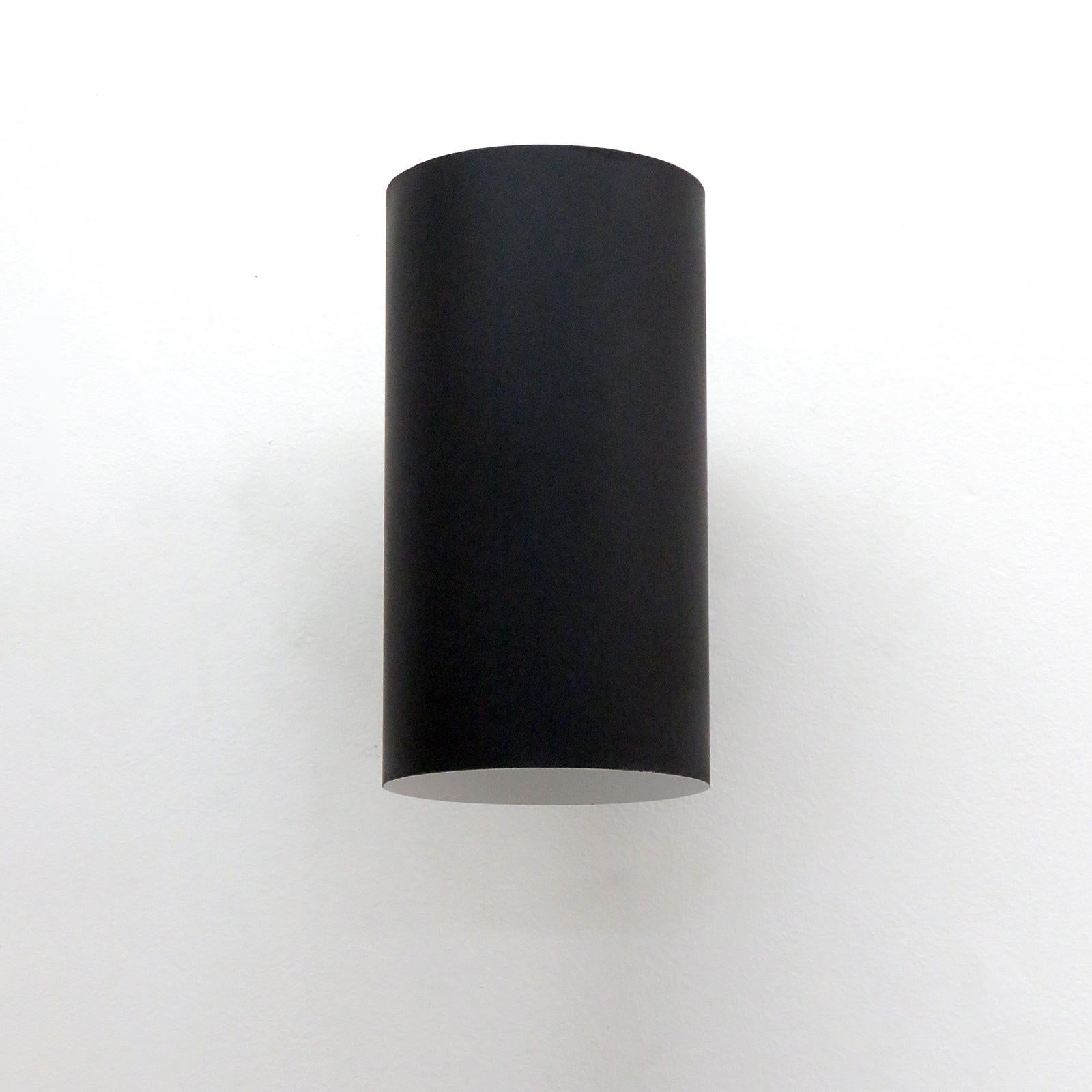 Elegant large cylindrical wall lights, model 71-474 by Ella & John Meiling for Louis Poulsen, 1970, in matte black finish, restored and wired for US standards, two E26 sockets per fixture, max. wattage 100w each, bulb provided as a onetime courtesy.
