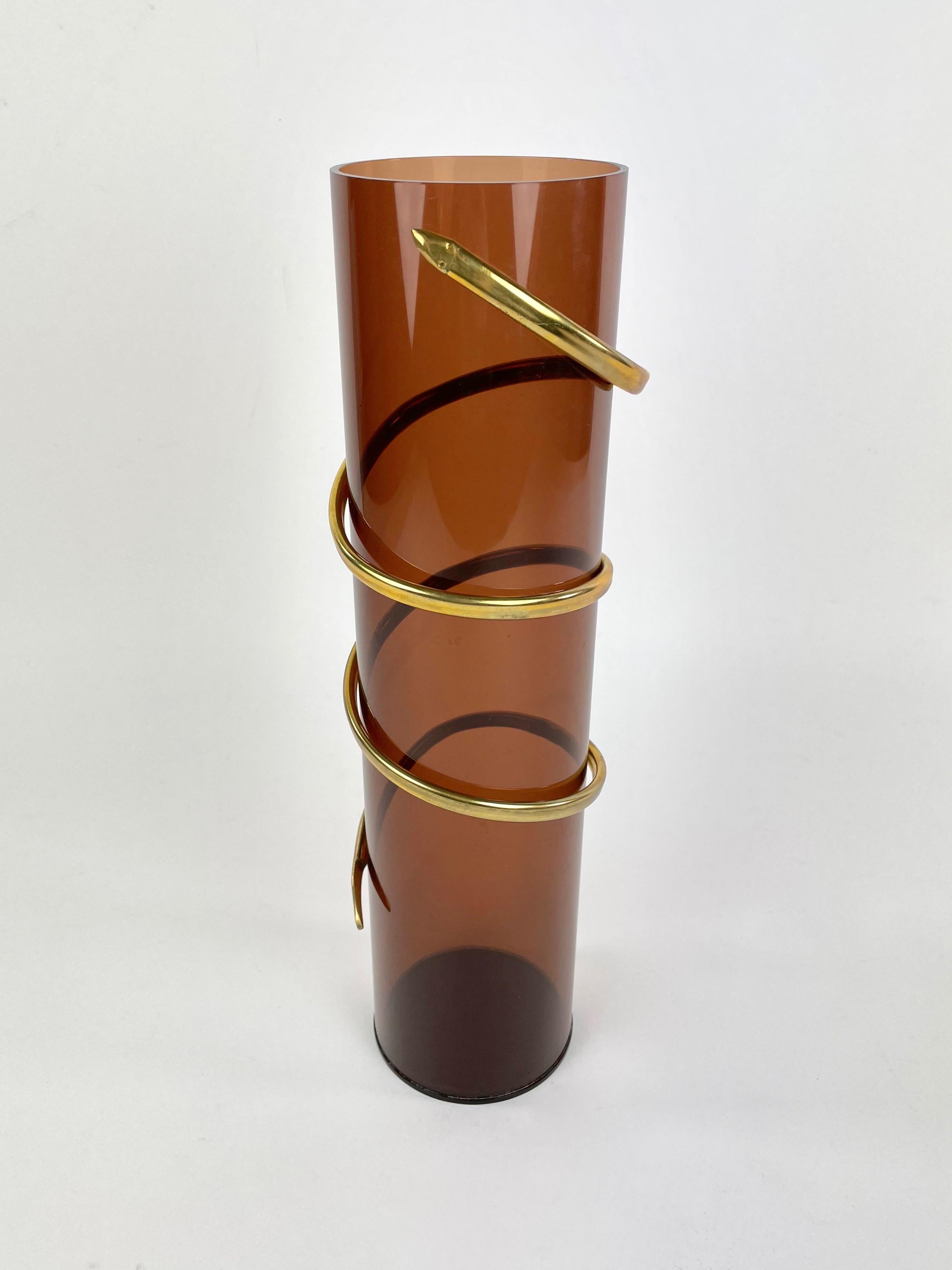 Cylindric vase in Lucite featuring twisted snake in brass. Made in Italy in the 1970s.