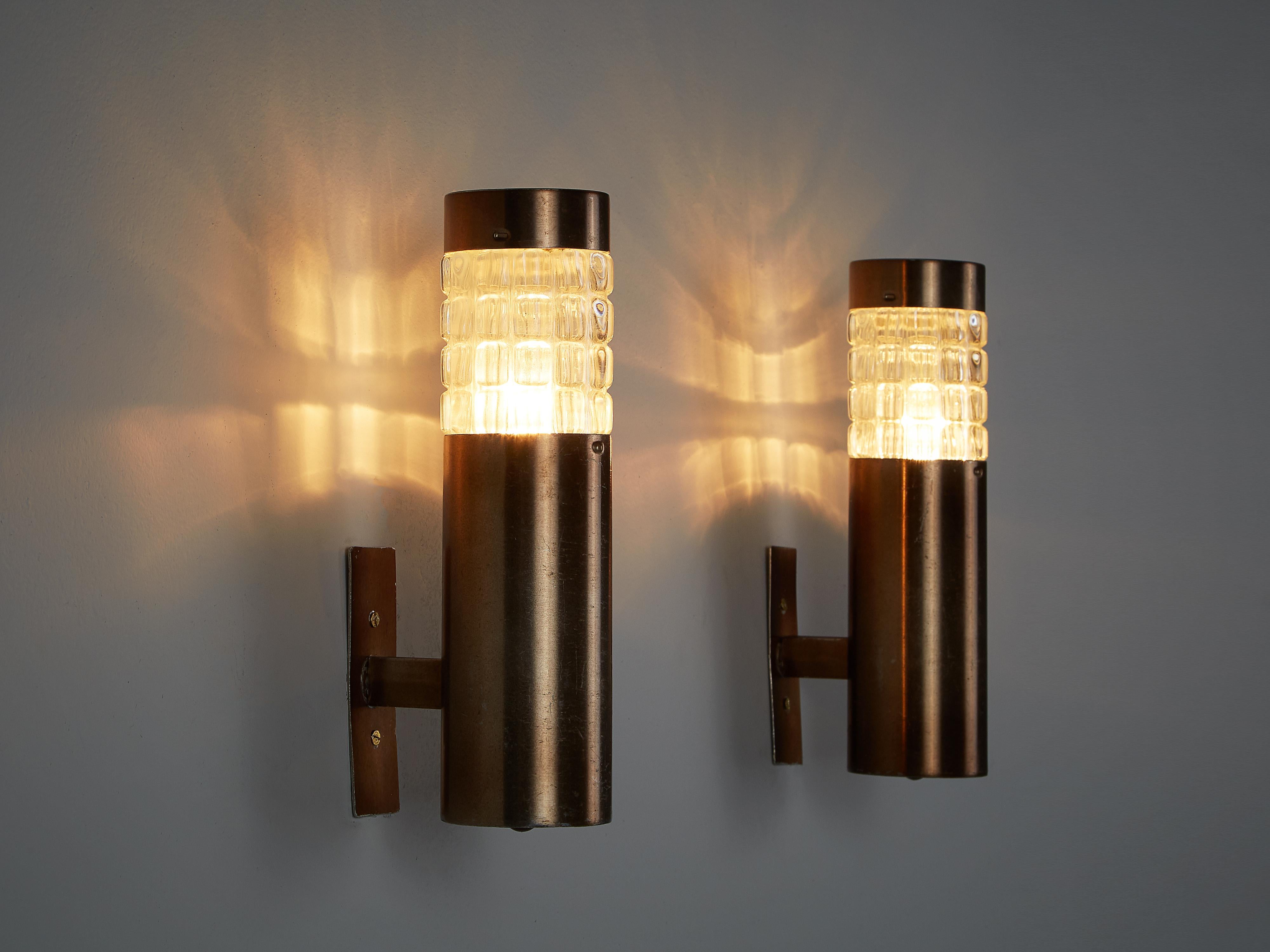 Wall lights, metal, cut glass, Italy, 1970s

These lovely sconces embody a clear construction based on a cylindric shape. The glass is cut in squares, creating an interesting pattern on the wall when lit. The copper colored metal forms a nice