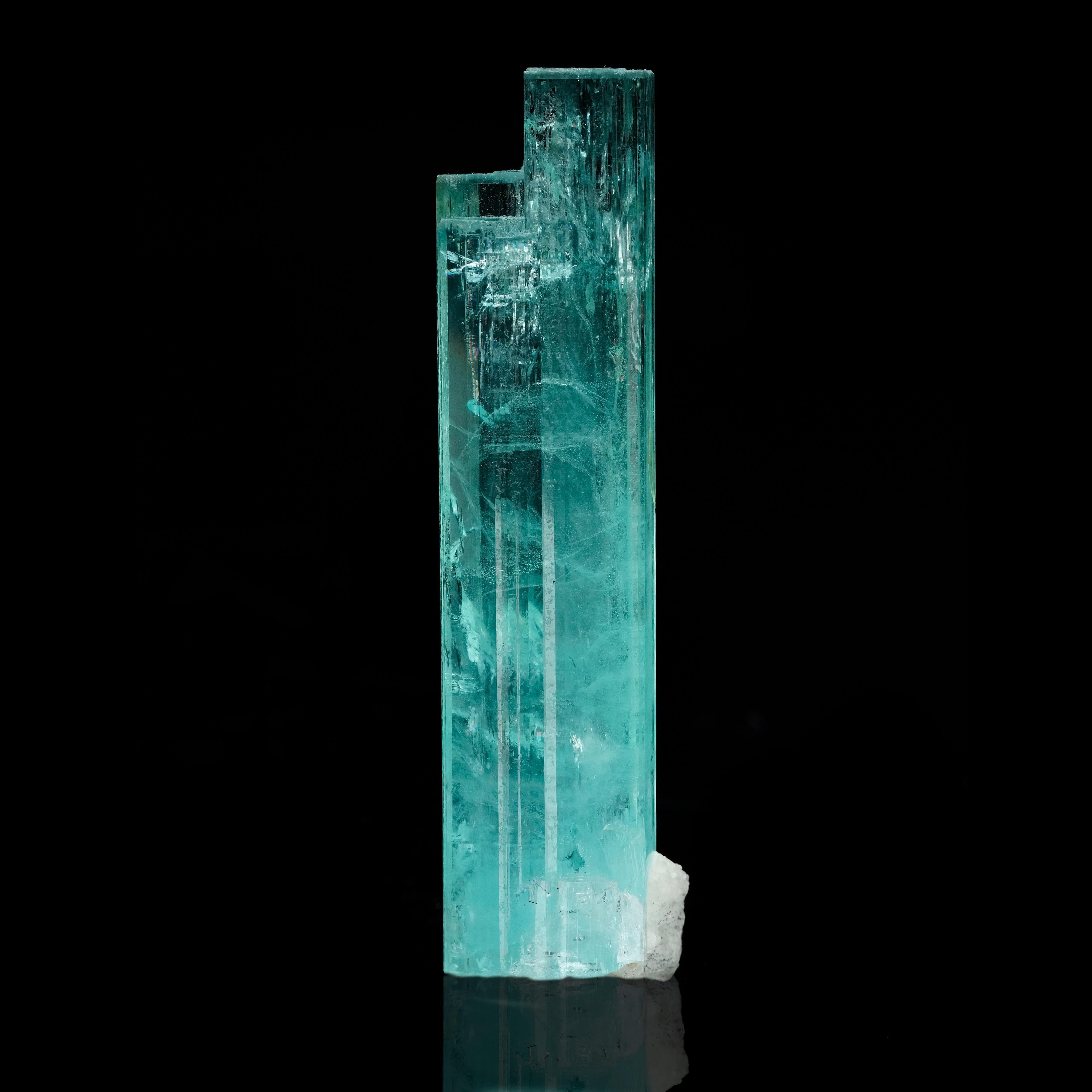 Discover the breathtaking beauty of this cylindrical aquamarine with feldspar from the rich mines of Pakistan. This unique gemstone features a striking combination of aquamarine's serene blue tones and the intricate textures of feldspar, making it a