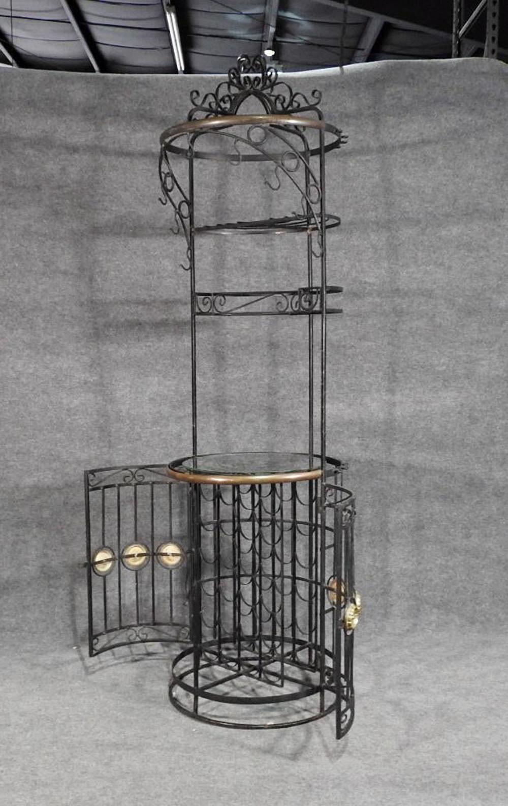 This is a gorgeous cylindrical wrought iron wine rack. The rack has some signs of age and use, and some previous old repairs as shown but is so beautiful and still functional, it's worthy of your attention. The styling is fantastic. Bronze accents.