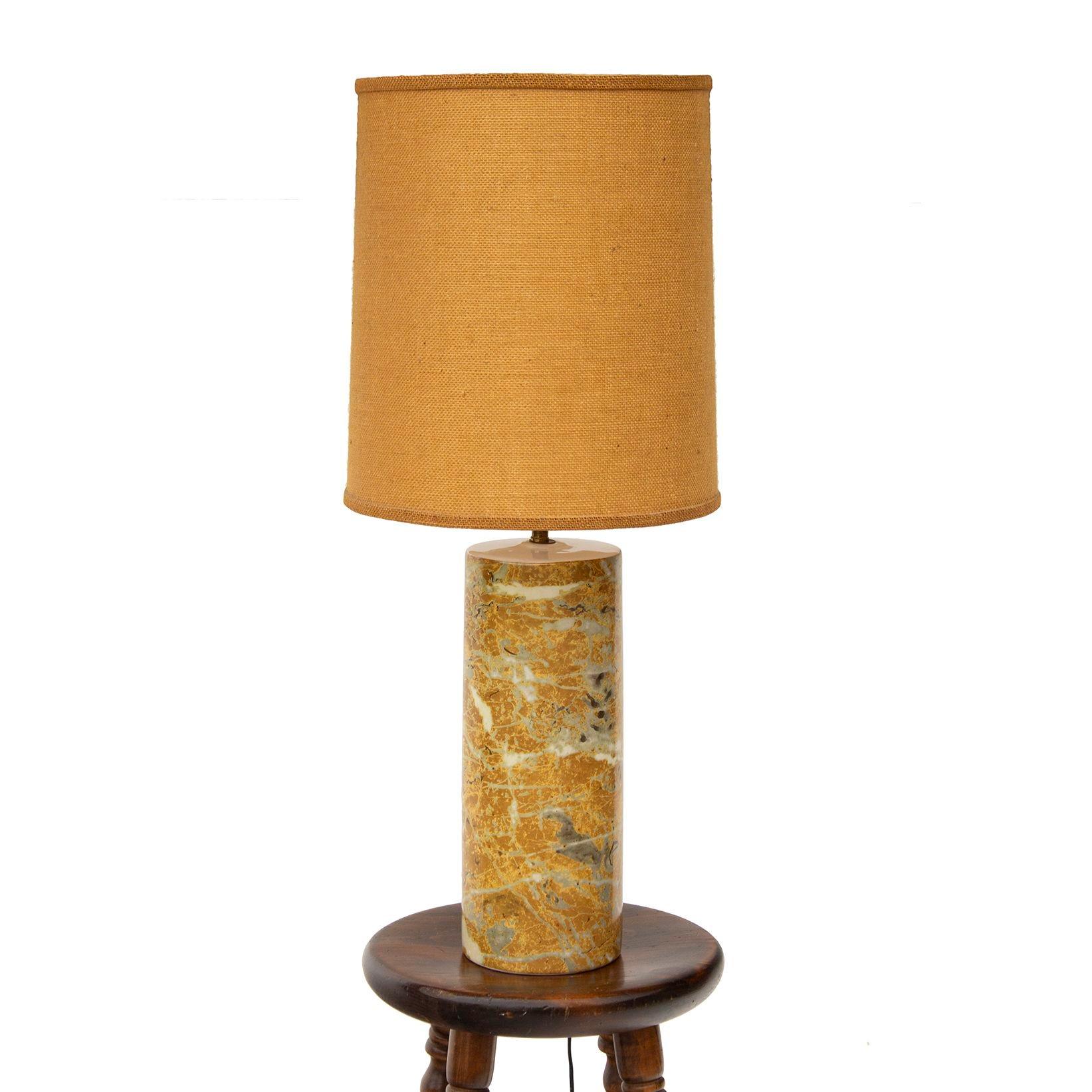 USA, 1970s
Cylindrical Ceramic Table Lamp in Faux Marble with natural tweed drum shade. Estate purchase, interesting design as the marble look appears applied to the column of the lamp, yet only when the seam can be seen from the back. Great