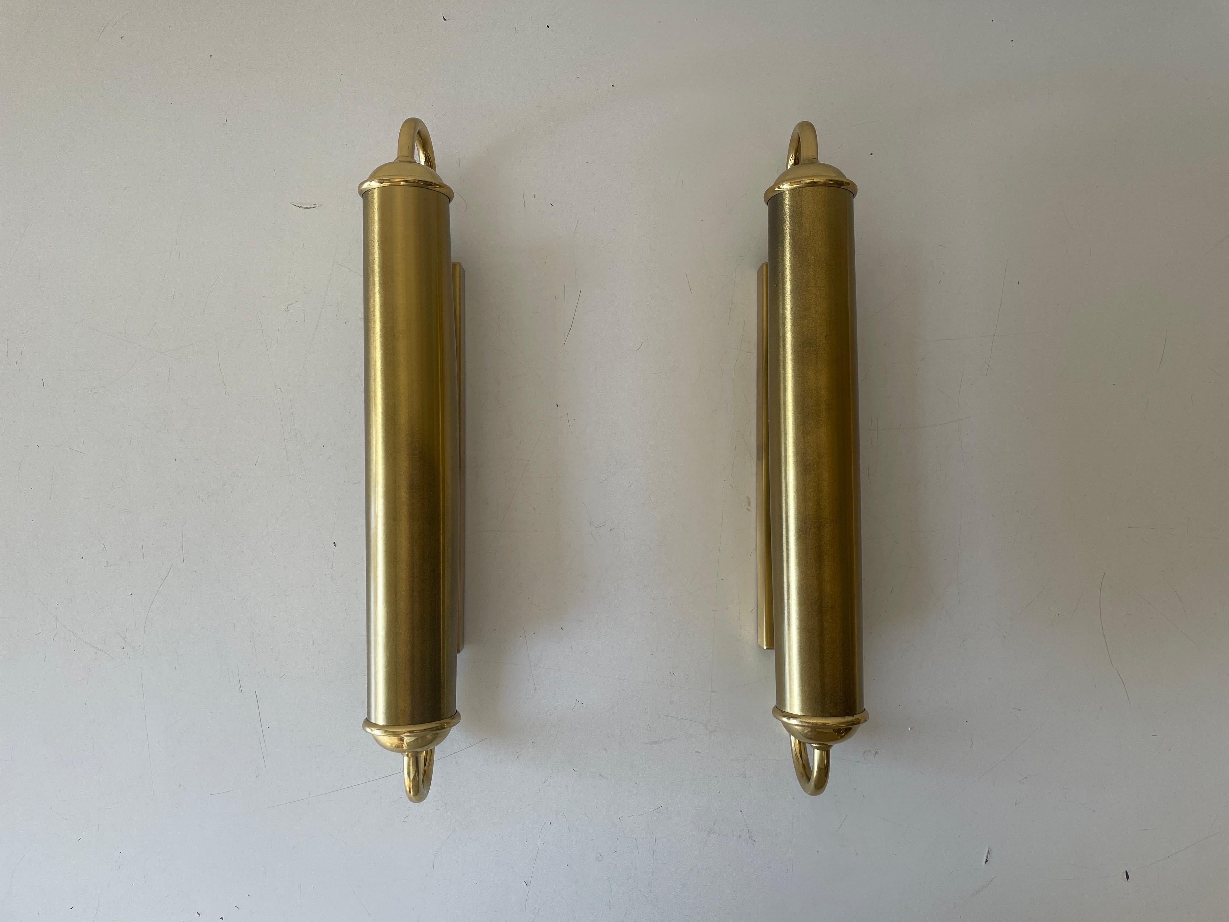 Cylindrical Design Art Deco Style Brass Pair of Sconces, 1960s, Germany

Very nice high quality wall lamps.

Lamps are in very good vintage condition.

These lamps works with 2x E14 standard light bulbs. 
Wired and suitable to use in all countries.