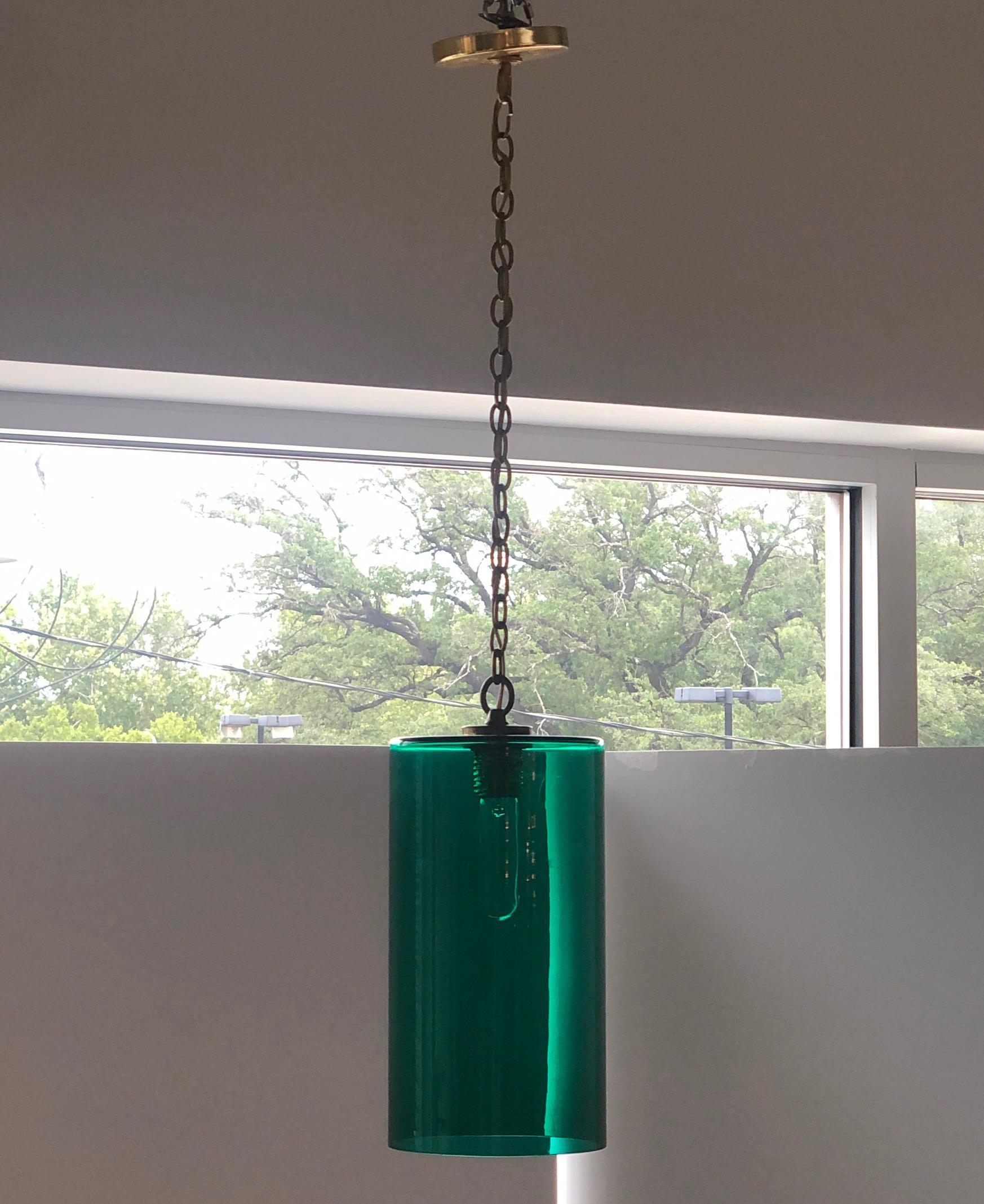 Offered is a Mid-Century Modern Italian cylindrical Murano glass with brass accents pendant / chandelier in a rich emerald green. This piece is clean, simple, Classic and quite versatile. It would look lovely in a foyer, powder room, nursery,