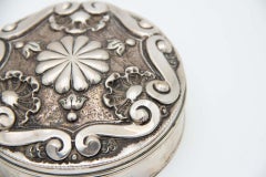 Cylindrical jewelry box with floral motifs and embossed shells