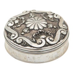 Cylindrical jewelry box with floral motifs and embossed shells