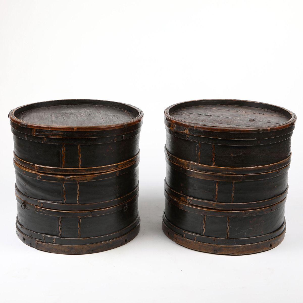 A pair of cylindrical side tables, originally Chinese antique stackable boxes.

Crafted from linden wood and bamboo, they feature the original black lacquer finish with a beautifully aged patina.

Elegant and versatile as a pair of side tables.
Only