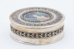 Cylindrical silver jewelry box with antique lady engraving on the lid
