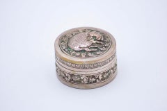 Cylindrical silver rosary box with embossed pig figure