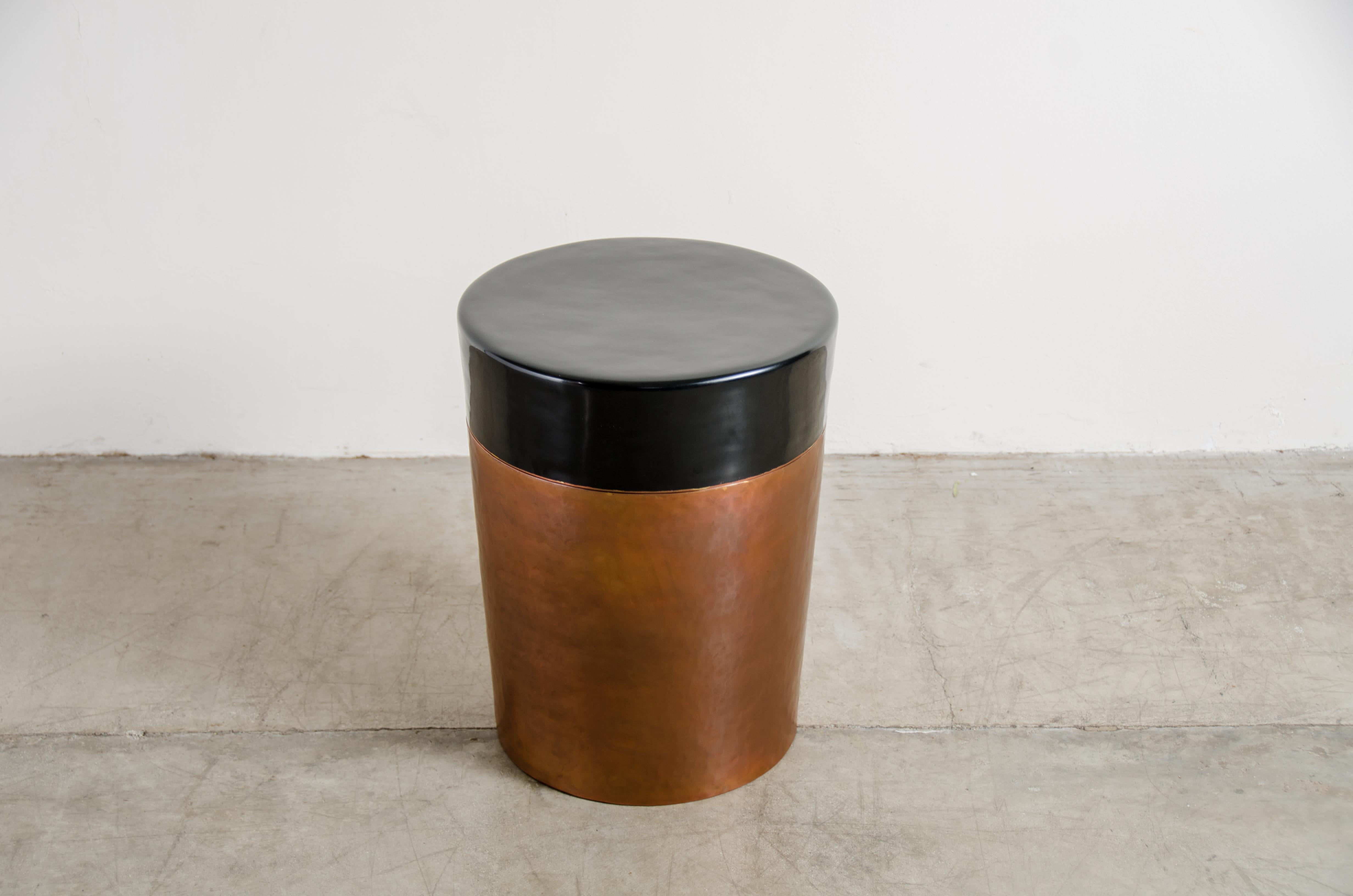 Cylindrical storage Drumstool
Antique copper
Black lacquer
Hand repousse
Limited Edition
Each piece is individually crafted and is unique.

Repousse´ is the traditional art of hand-hammering decorative relief onto sheet metal. The technique
