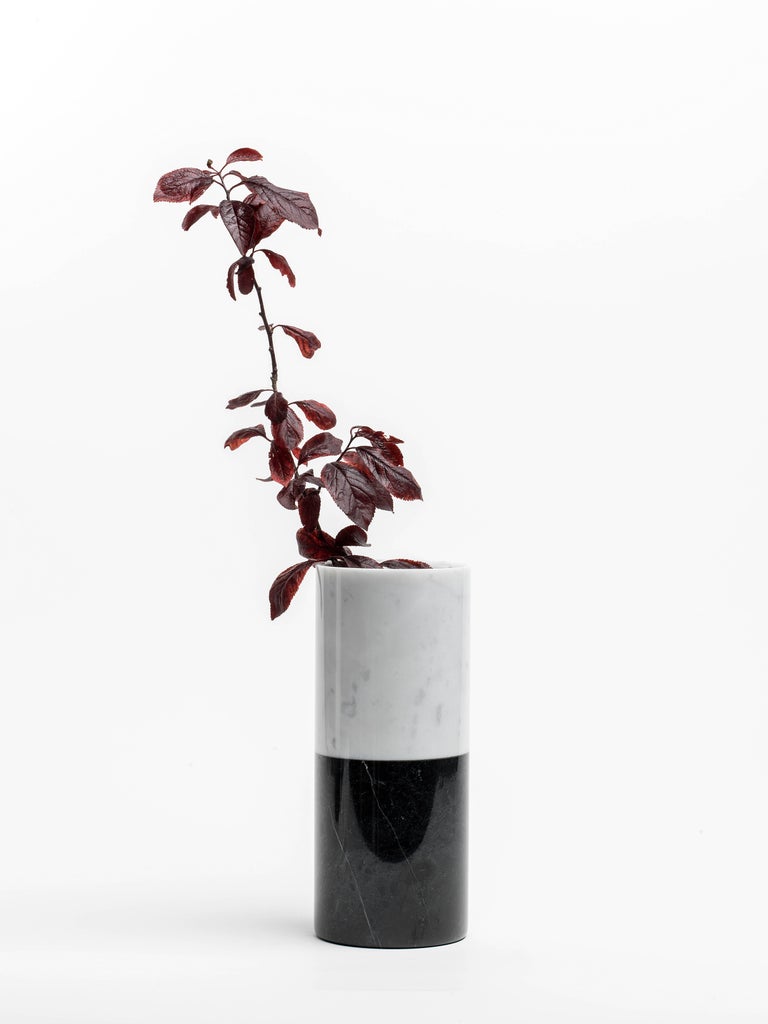 Cylindrical white Carrara marble vase with bottom black Marquina marble stripe, made in Italy, Carrara.
Each piece is in a way unique (since each marble block is different in veins and shades) and handcrafted in Italy. Slight variations in shape,