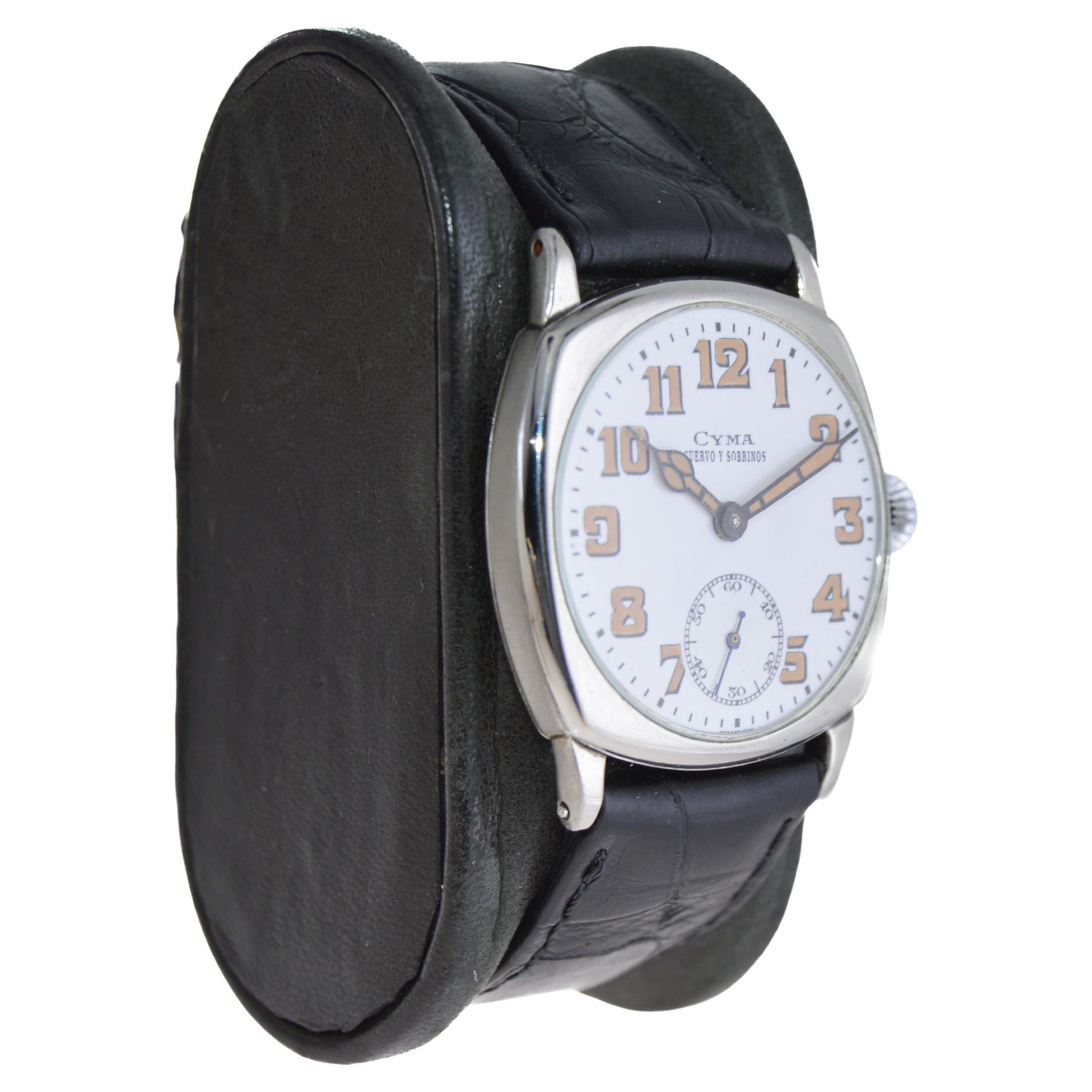 FACTORY / HOUSE: Cyma Watch Company for Cuervo & Sobrinos
STYLE / REFERENCE: Art Deco Cushion Shape 
METAL / MATERIAL: Nickel Silver
CIRCA / YEAR: 1920's
DIMENSIONS / SIZE: 38mm Length X 32mm Width
MOVEMENT / CALIBER: Manual Winding 
DIAL / HANDS: