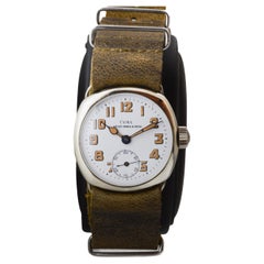 Reloj Cyma estilo campaña de níquel con esfera original esmaltada al horno 1915