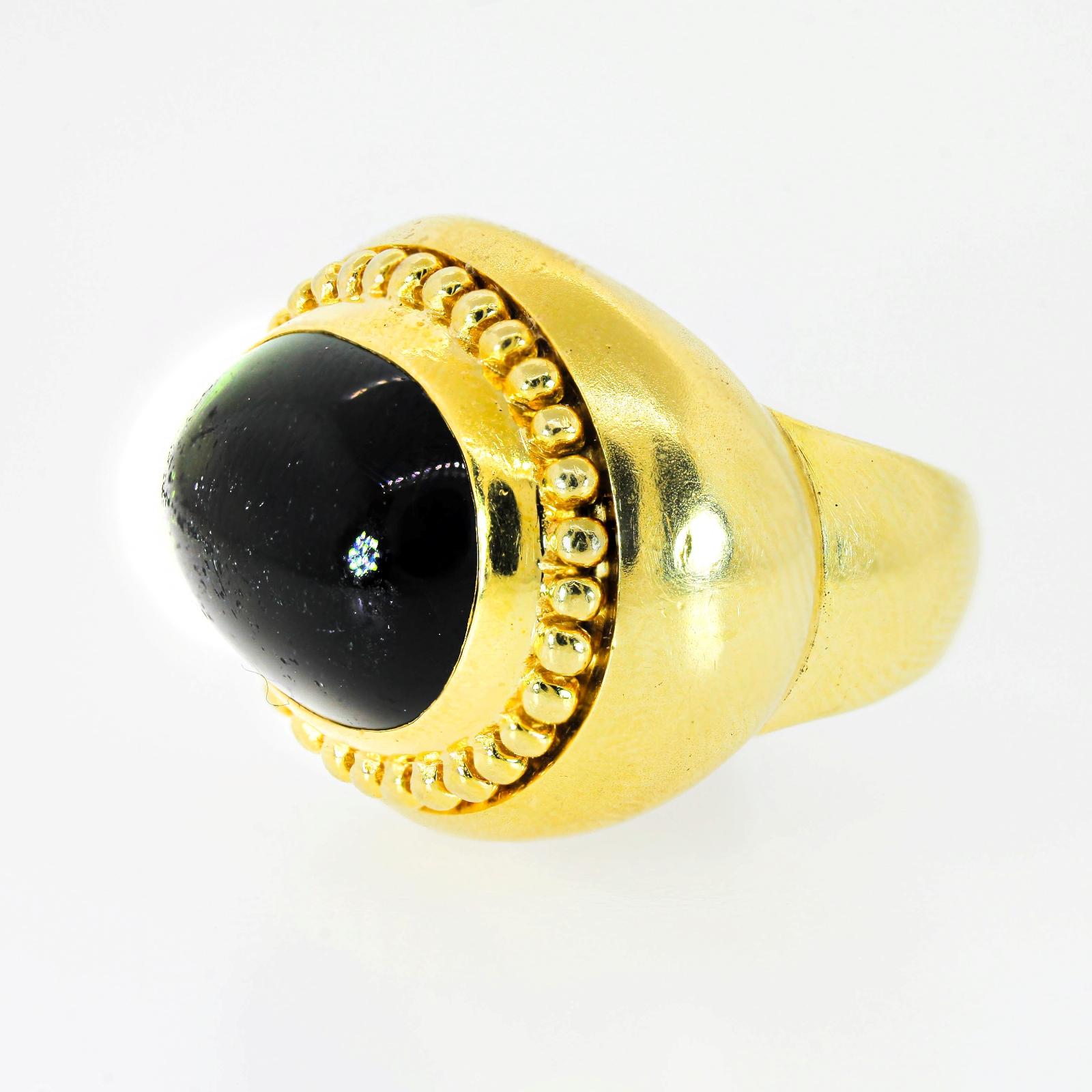 Green Tourmaline also known as Verdelite is prehaps nature's best healing gem.  This bold Cynthia Bach's 18KT yellow gold ring features an approx. 12.00 carat cabochon green Tourmaline, measuring 16.80 x 12.25 x 7.00 mm.  It is bezel set and