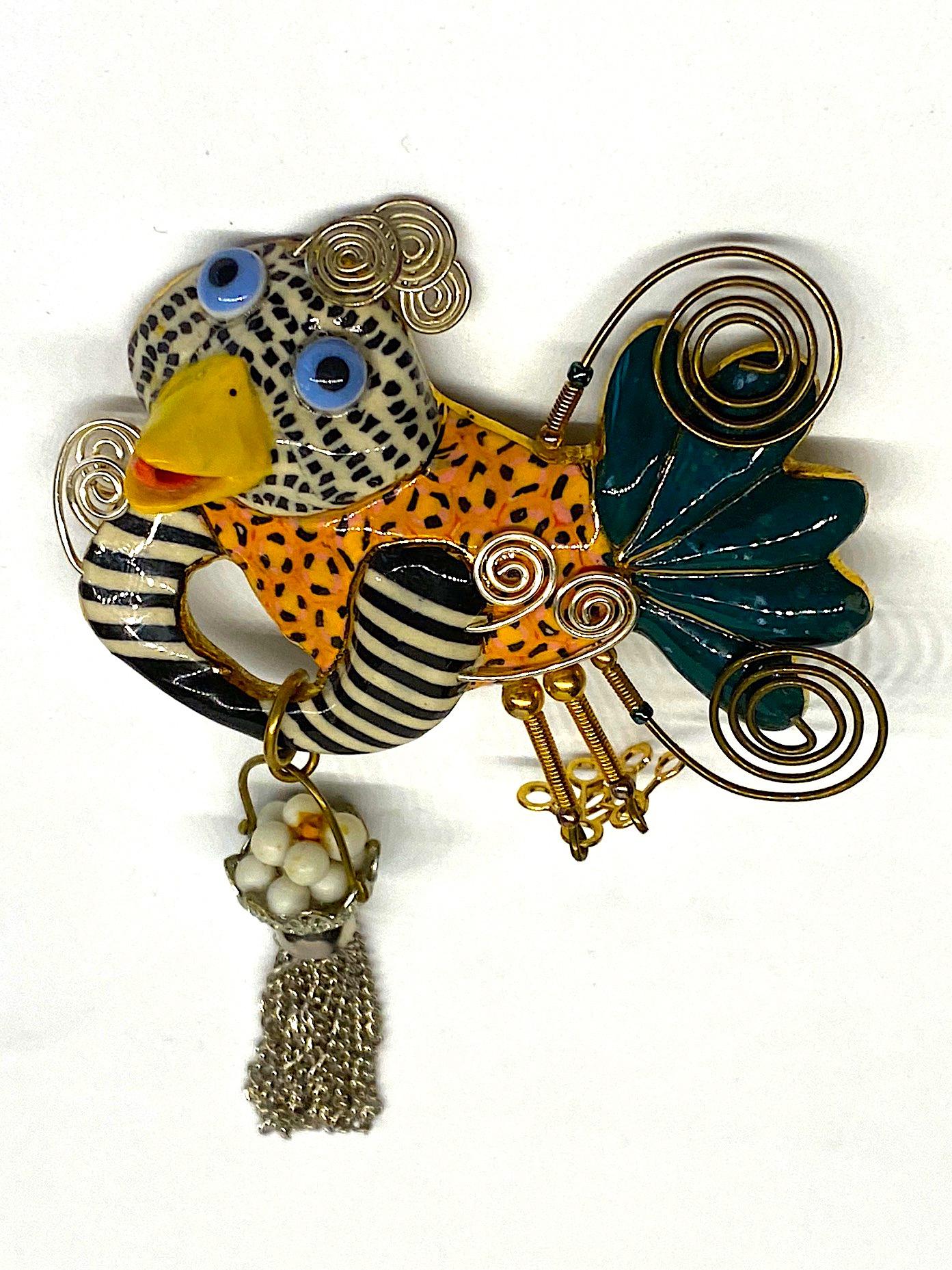Always with a sense of whimsy, Jewelry 10 pieces designed by Cynthia Chuang and her husband Erh-Ping Tsai are highly collected and displayed. This is a one of kind hand made brooch of a chicken with basket full of eggs from the company Jewelry 10. 