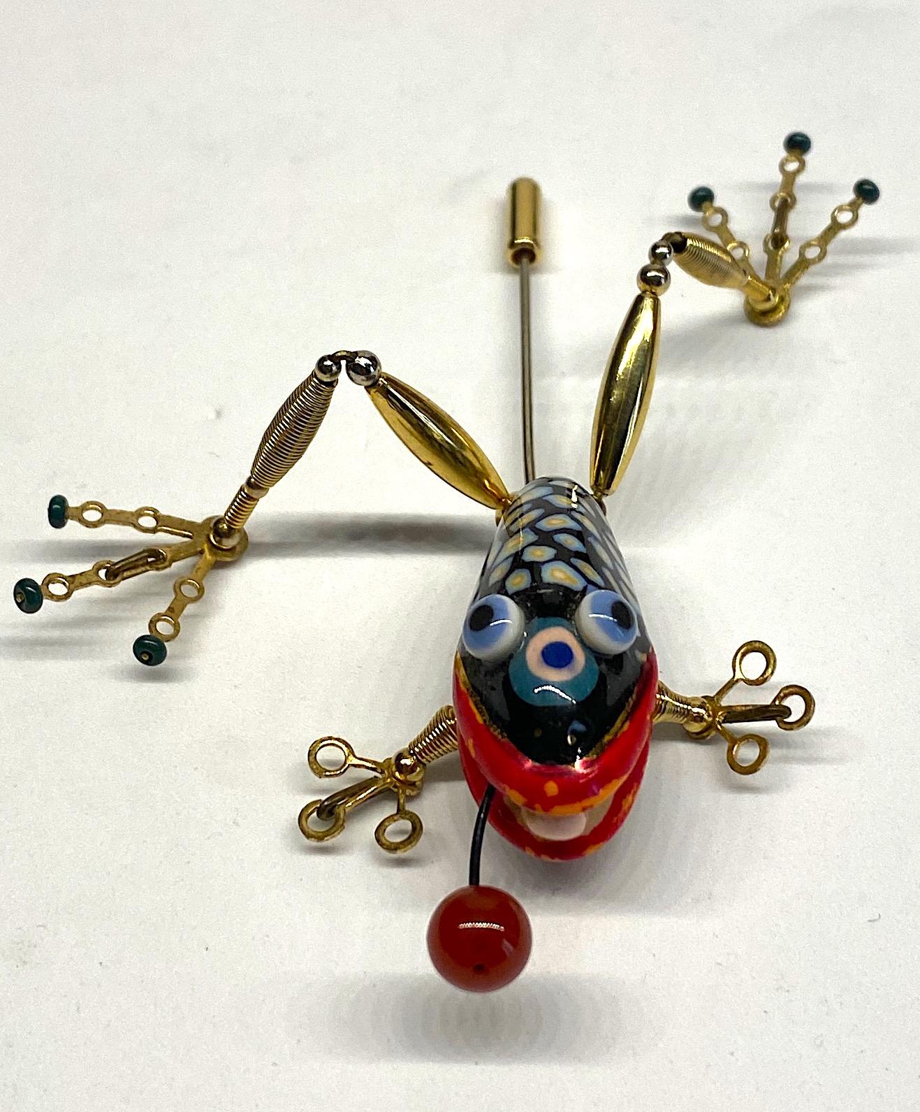 A one of kind hand made frog brooch from the company Jewelry 10. Always with a sense of whimsy, Jewelry 10 pieces designed by Cynthia Chuang and her husband Erh-Ping Tsai are highly collected and displayed. The frog porcelain body is meticulously