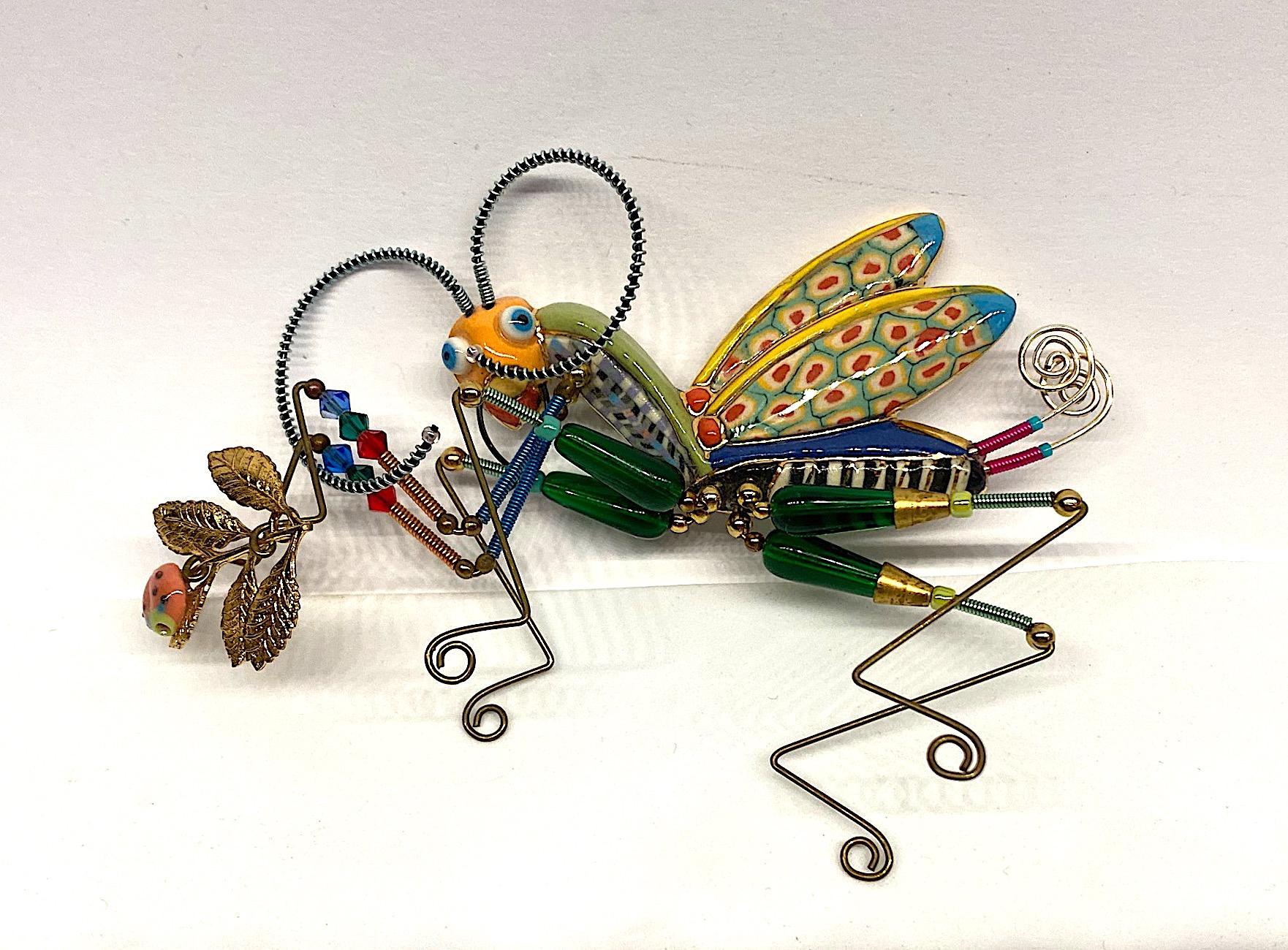 Always with a sense of whimsy, Jewelry 10 pieces designed by Cynthia Chuang and her husband Erh-Ping Tsai are highly collected and displayed. This is a large one of a kind praying mantis brooch holding a branch with lady bug from the company Jewelry