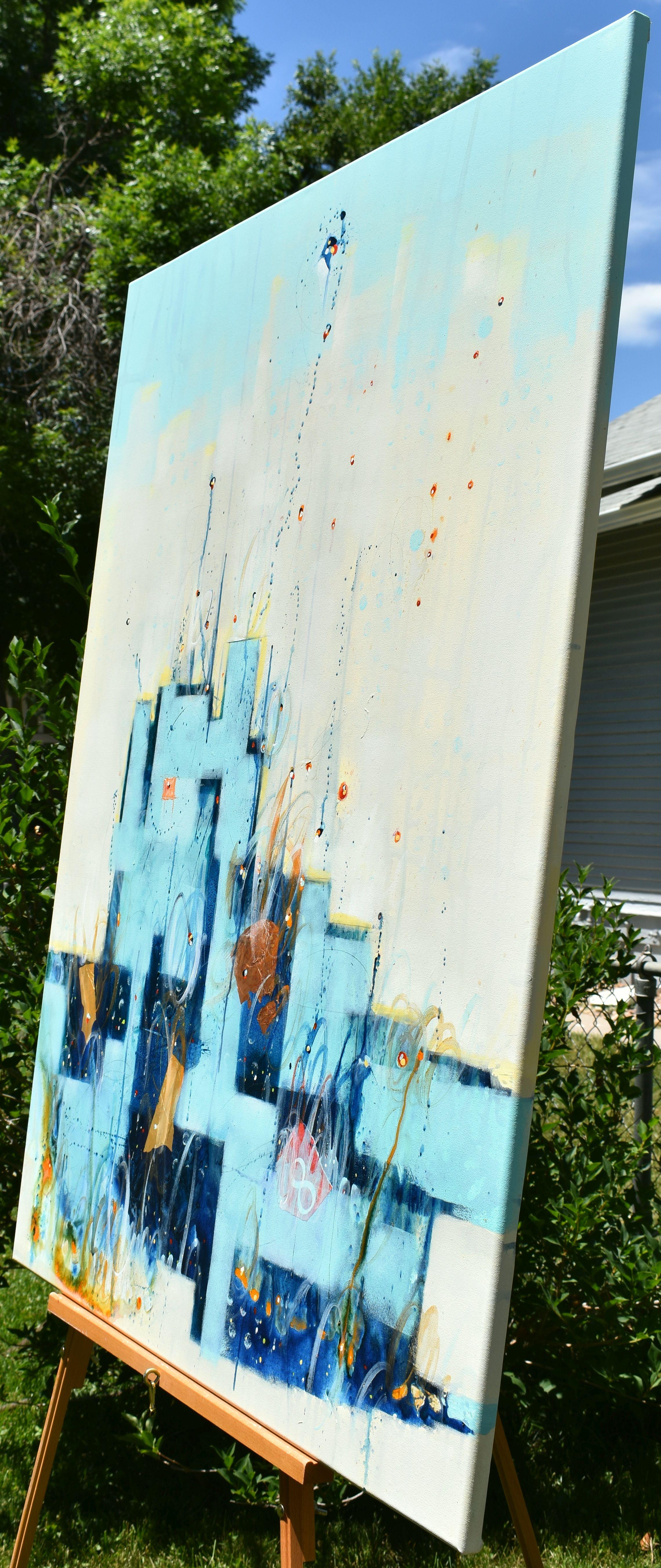 <p>Artist Comments<br />Blue geometric shapes rise against a soft yellow background, depicting a colorful urban sunset in December. Artist Cynthia Ligeros captures the essence of the winter solstice. Layers of paint and gold leaf create depth and