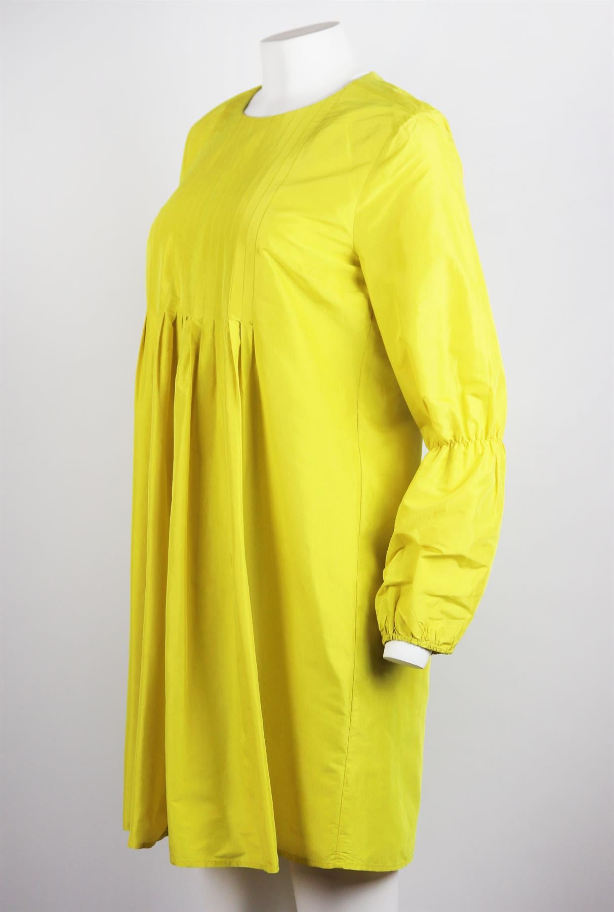 Cynthia Rowley's dresses always feel so feminine, even when they're as understated as this one, it's cut from silk and has a softly pleated detail on the bust which reveals a full skirt and sleeves. Yellow silk. Slips on. 100% Silk; lining: 100%
