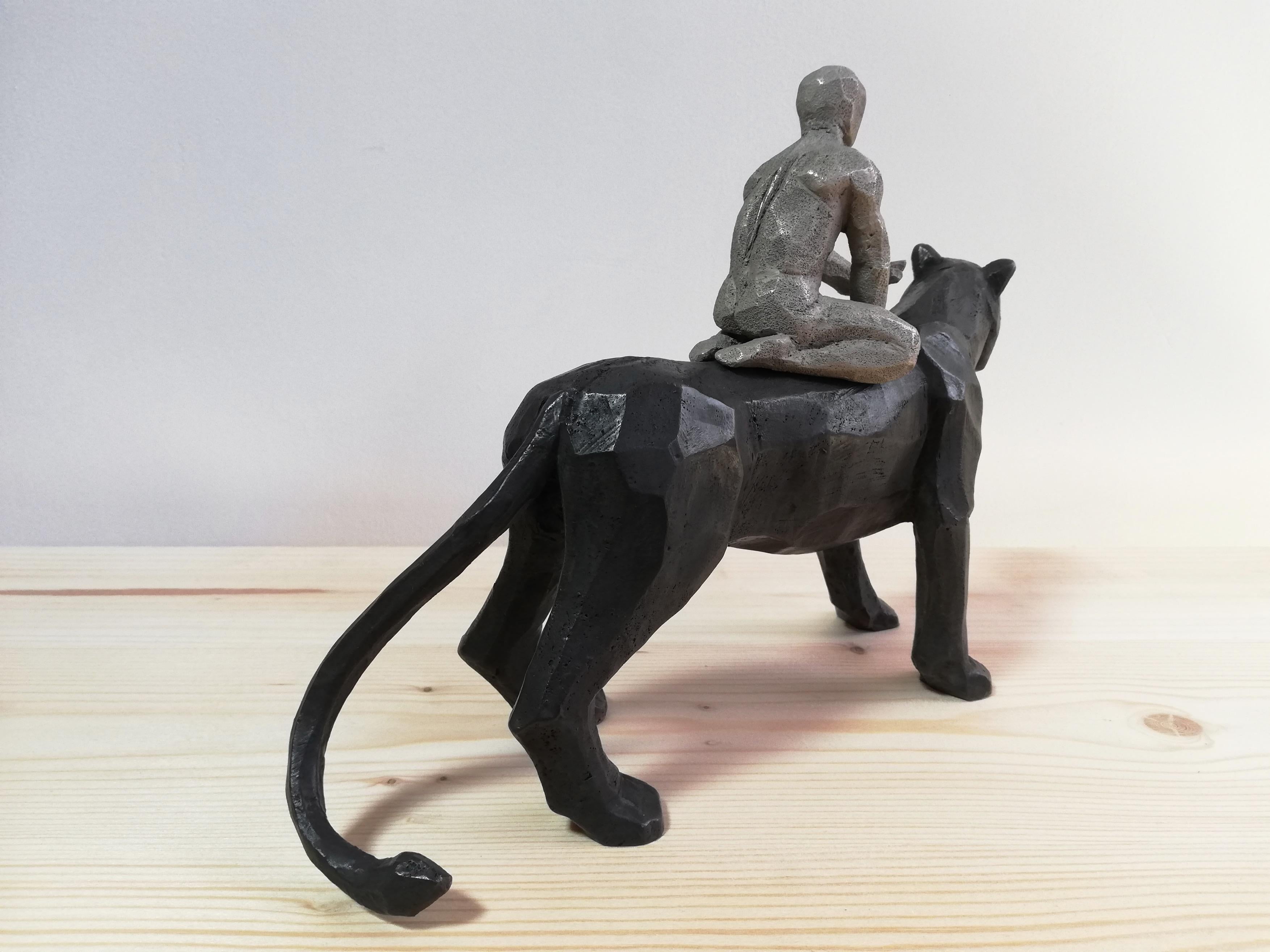 Passeur d'Ames bronze sculpture of a boy riding on a black panther's back  - Contemporary Sculpture by Cyrille André