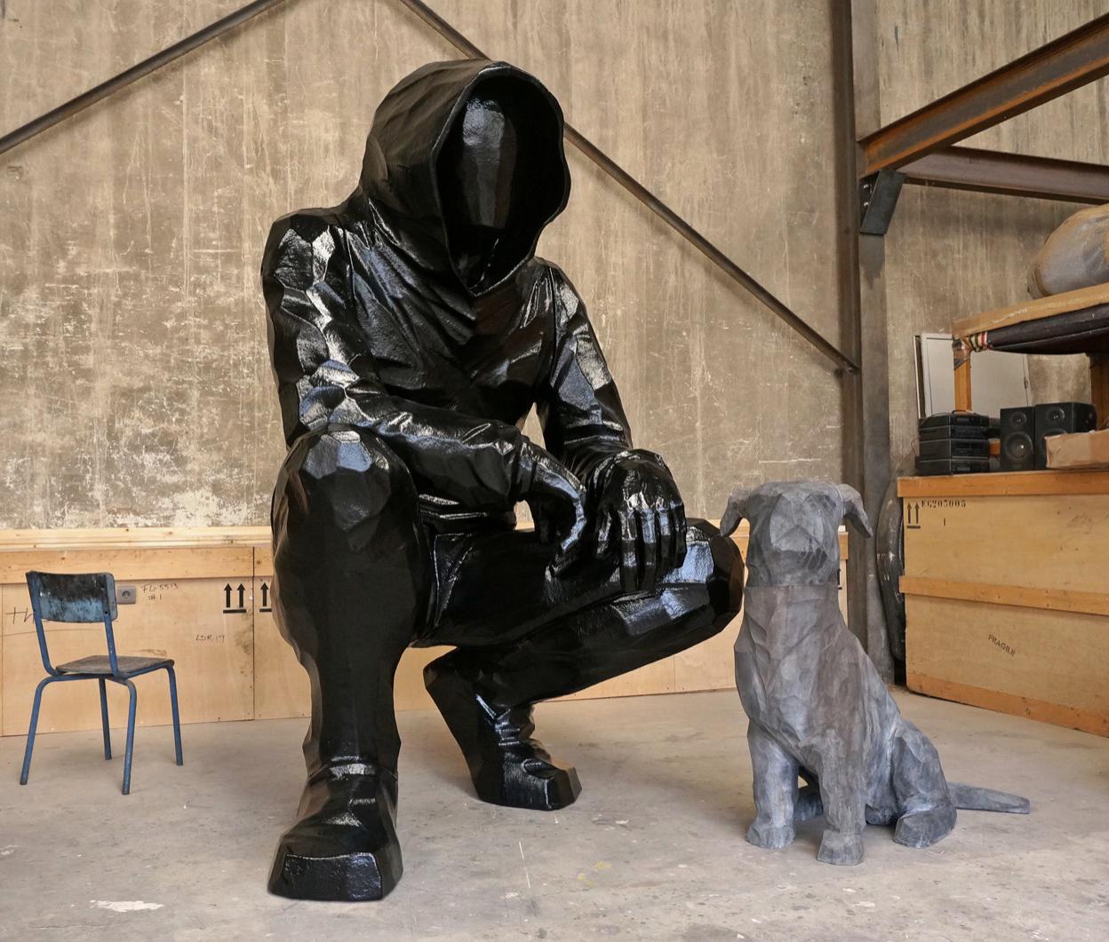 Cyrille André's gentle giant figure in black Polyester resin measures 99.5 x 63 x 61 inches and his dog in cast aluminum measures 43.25 x 46.5 x 21 inches. This is a unique sculpture.
