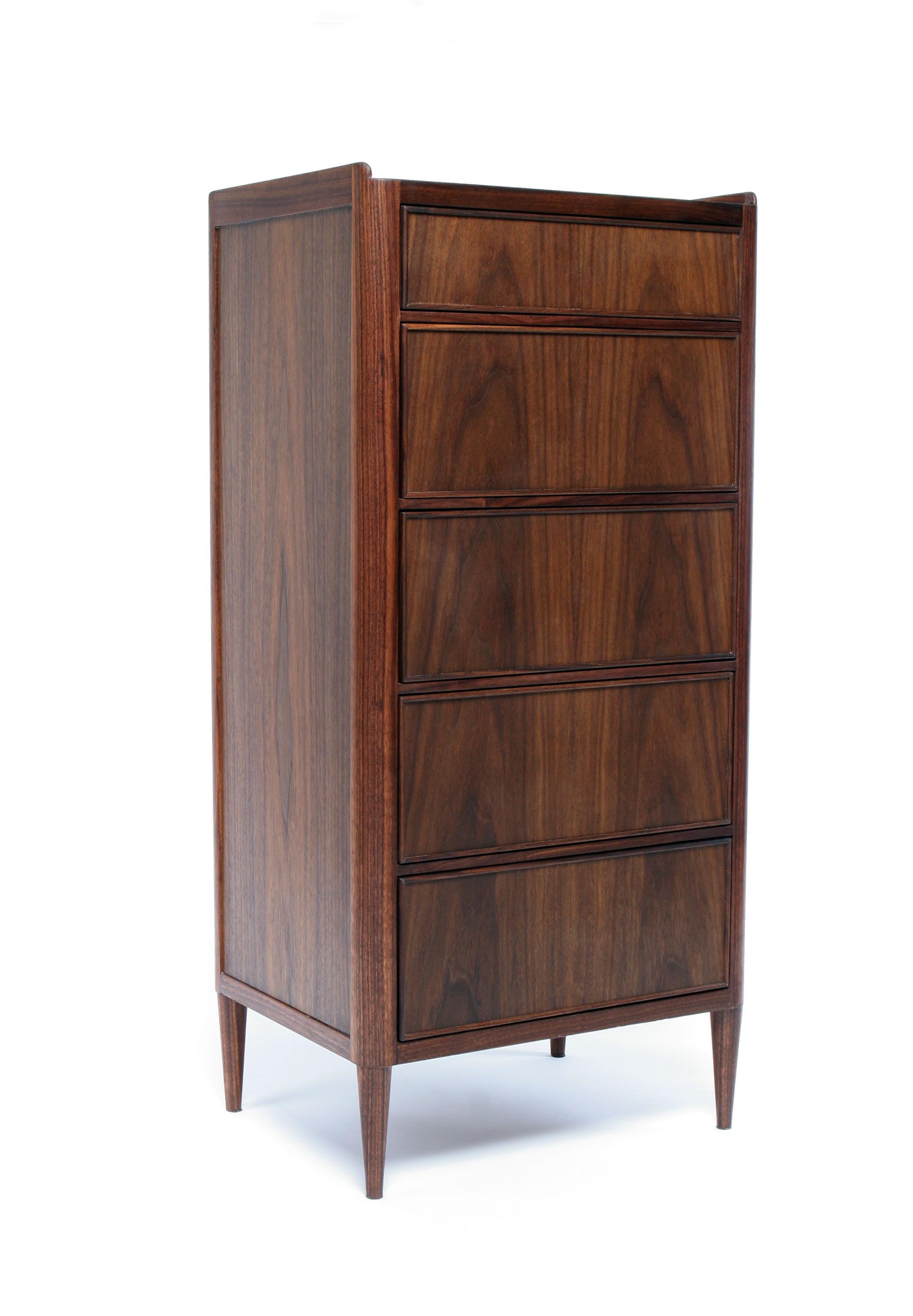 The Cyrus Cabinet features a frame made of hand-oiled solid walnut with inset panels of book-matched walnut veneer. The cabinet's five well proportioned drawers feature an all-around beading detail and touch-latch mechanism for opening. 

The