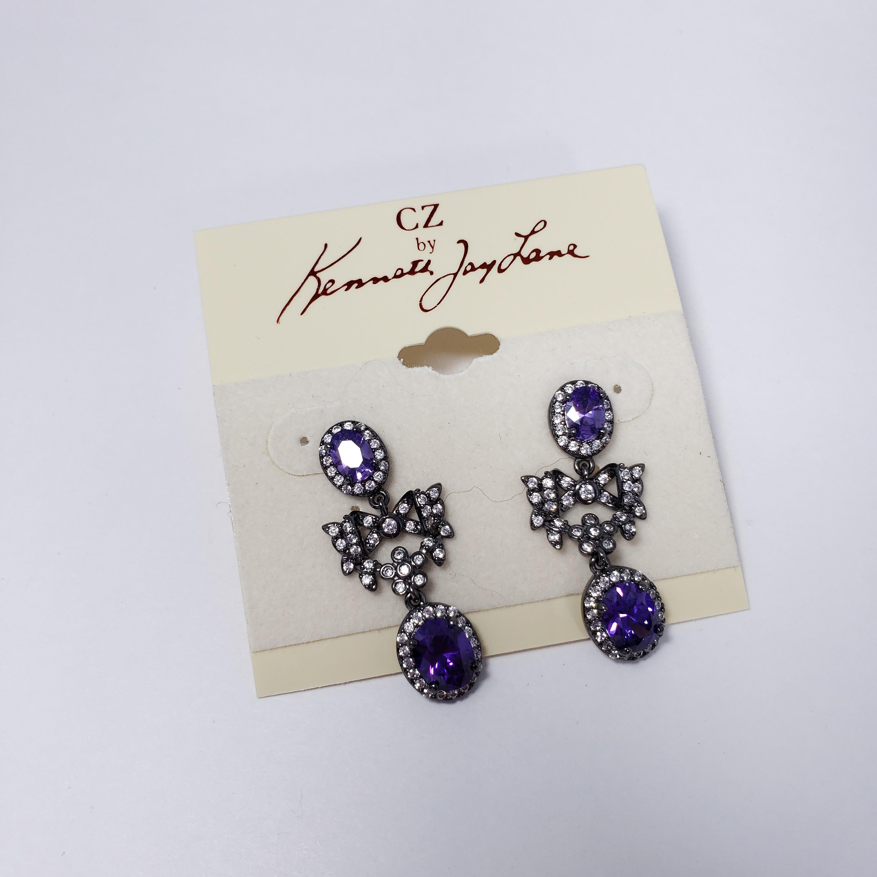 Cubic Zirconia by Kenneth Jay Lane P/8 Cttw oval with bow drop earrings . Each earring features two amethyst cubic zirconia crystals accented with clear crystals. Post backs.

Cubic Zirconia line by KJL. Designer sign.